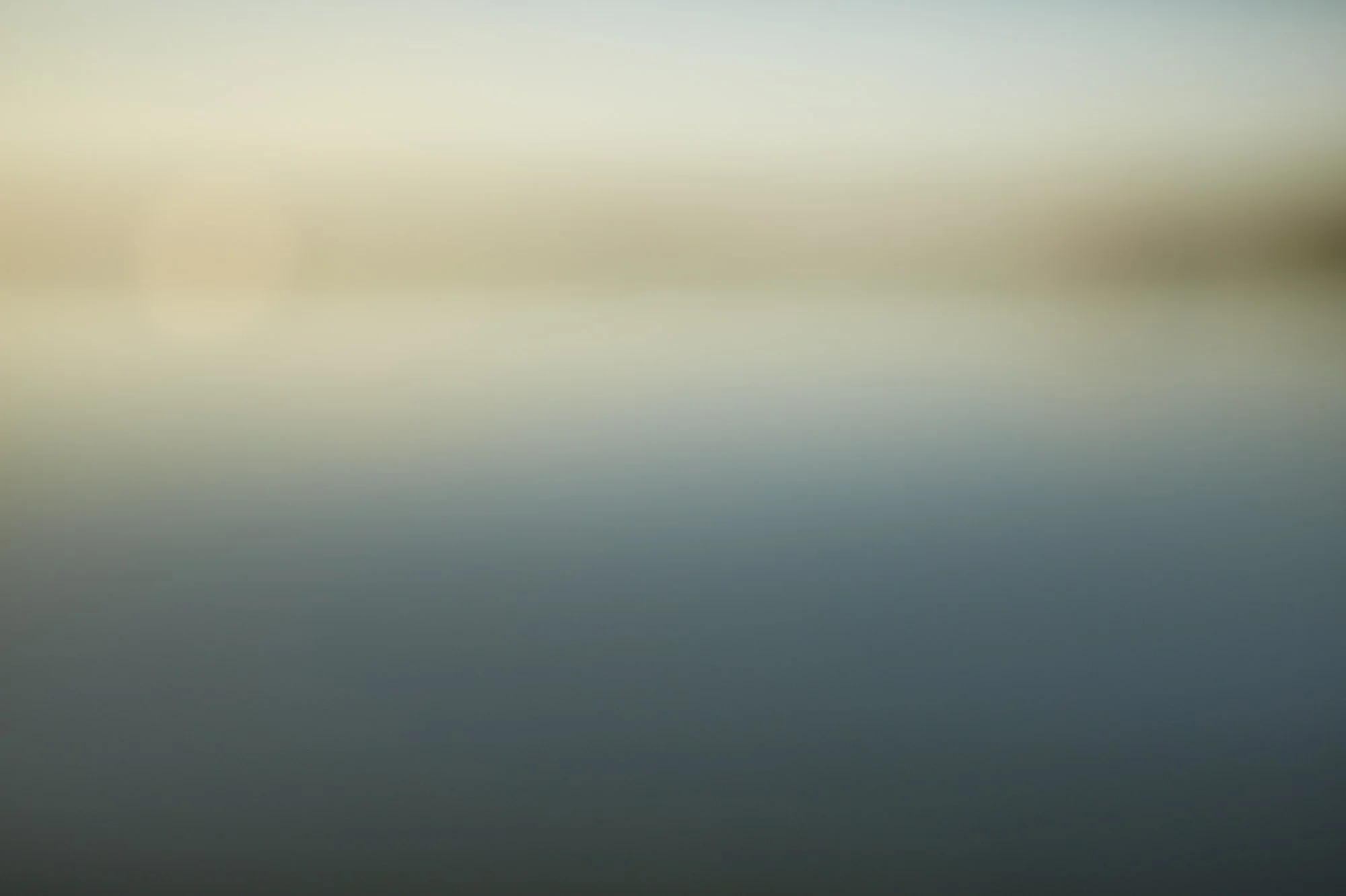 Blurred image with no distinct objects or details visible.