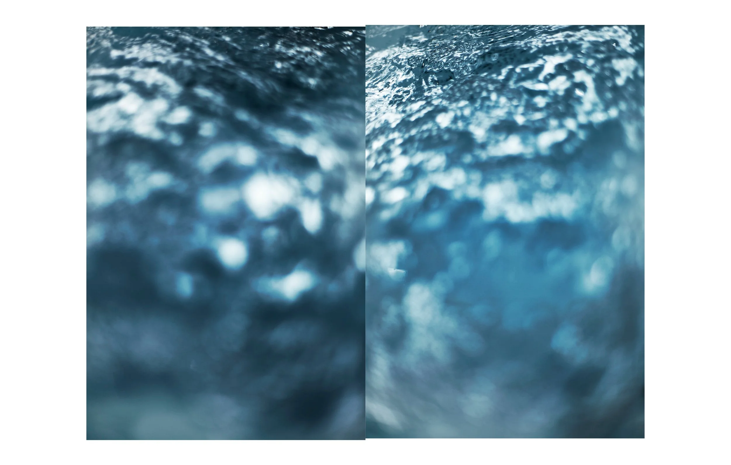 Close-up of moving water surface, showing ripples and bubbles in the water.