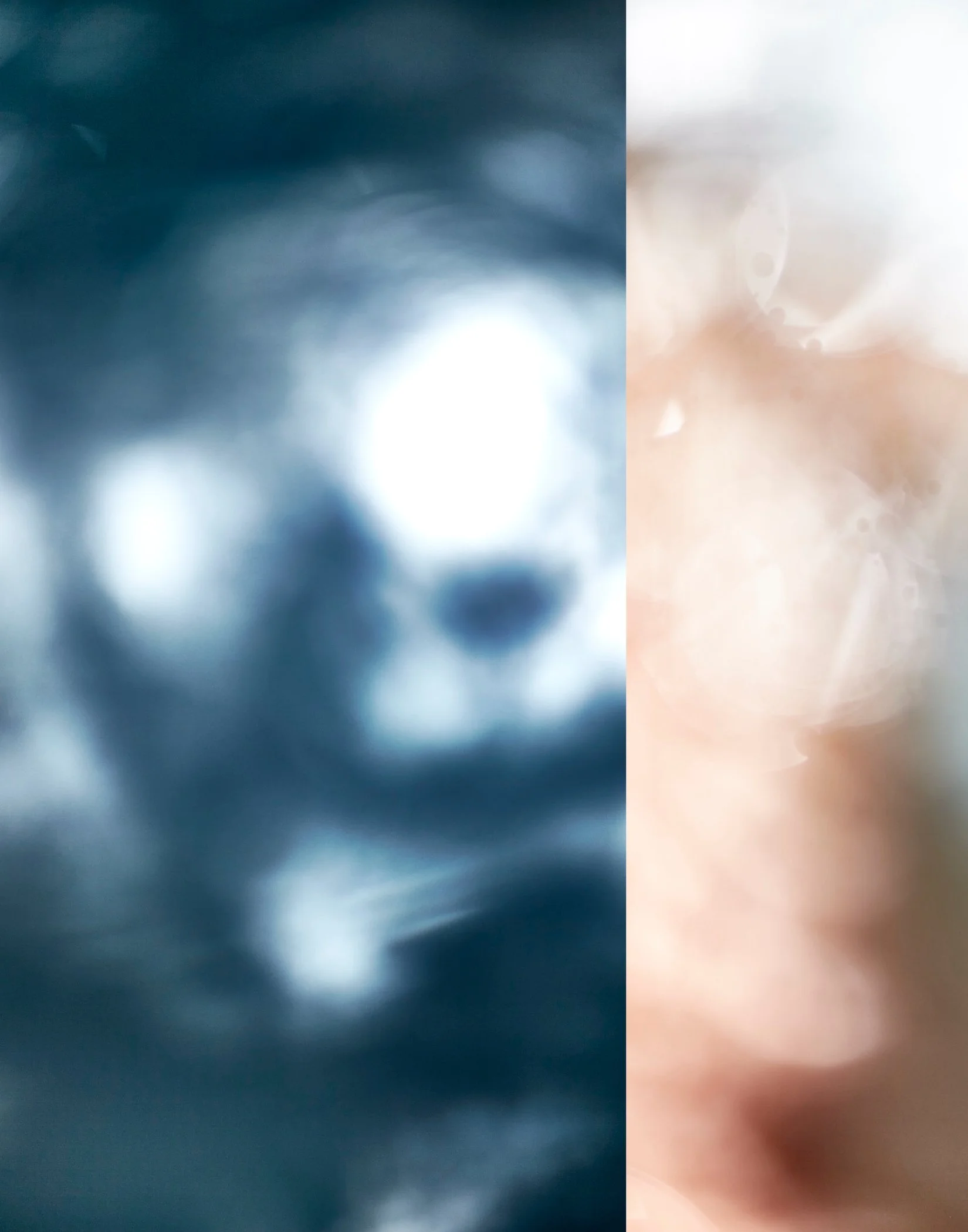 A blurred and abstract image with dark blue and white colors on the left side, and light pink and white colors on the right side, divided vertically.