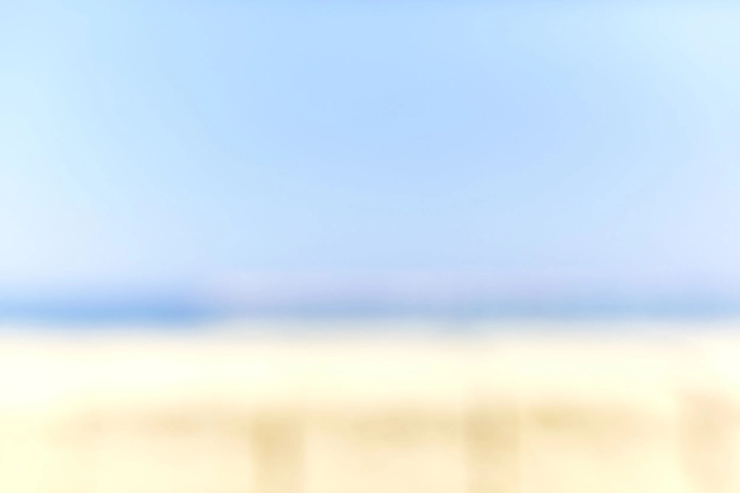 The image shows a gradient sky transitioning from light yellow at the bottom through light blue to a deep blue at the top.