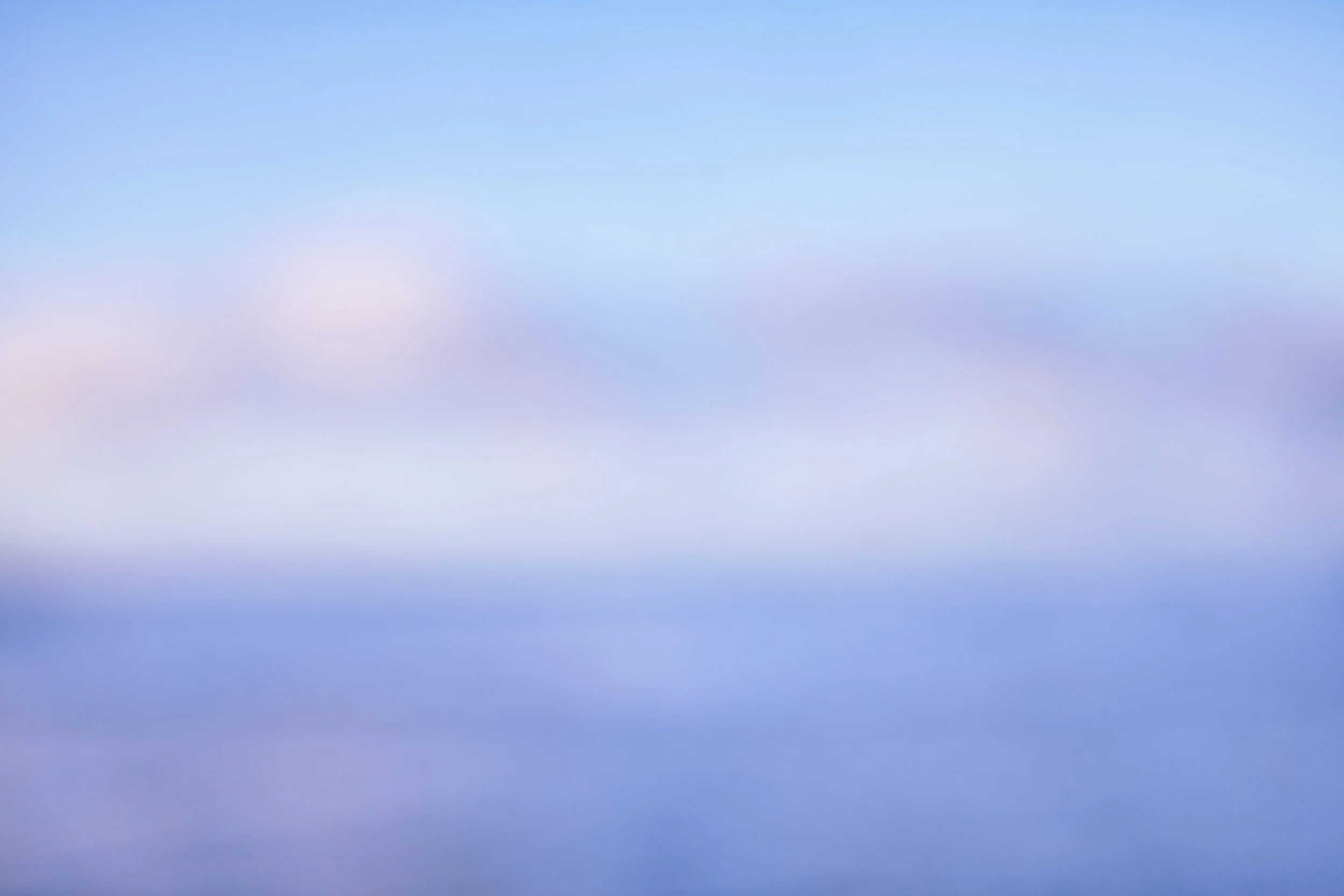 A sky with a gradient of blue and pastel pink and purple hues, resembling a calm, clear sky at sunrise or sunset.