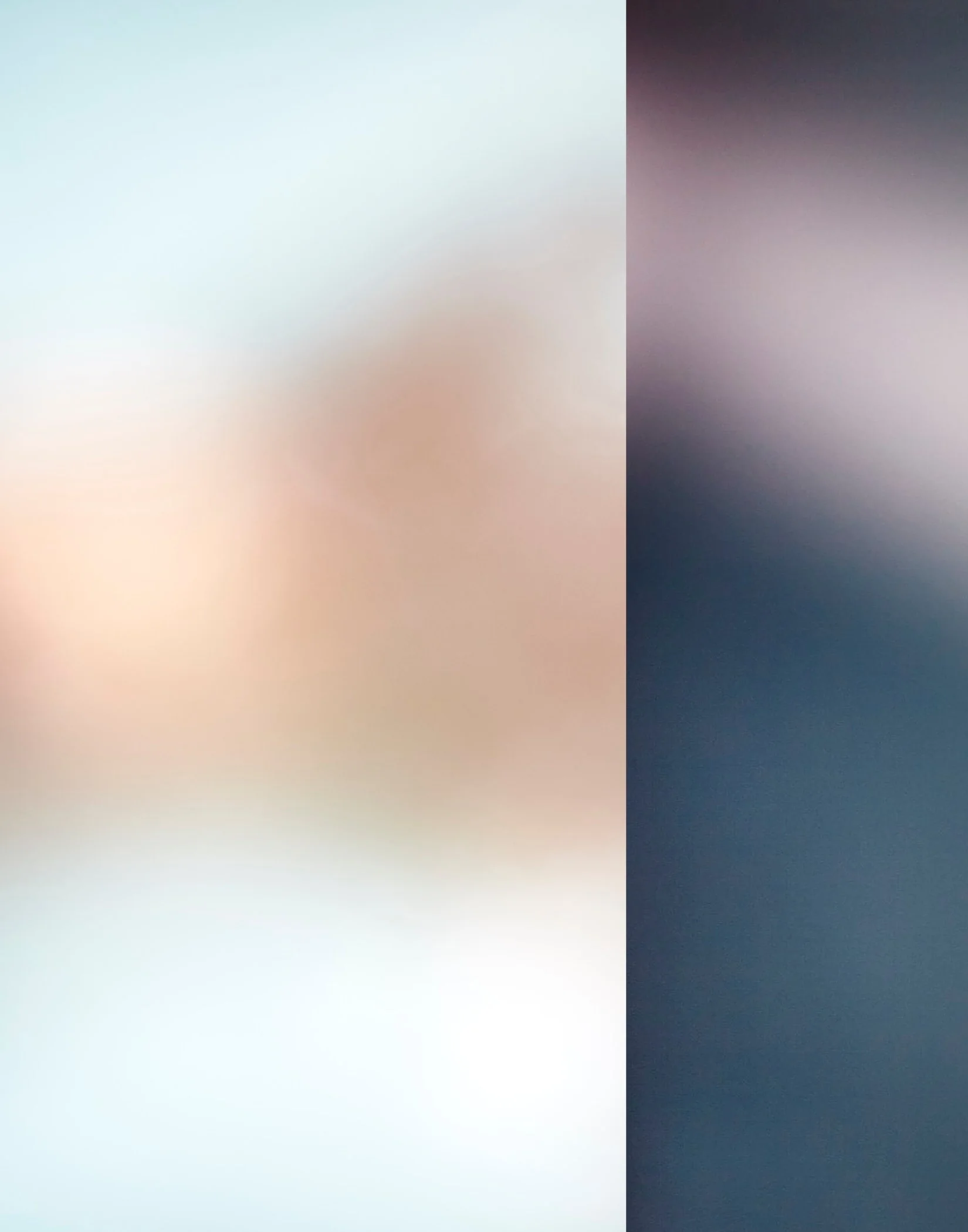 Blurred gradient background with soft transition from pale blue and beige on the left to dark purple and black on the right.