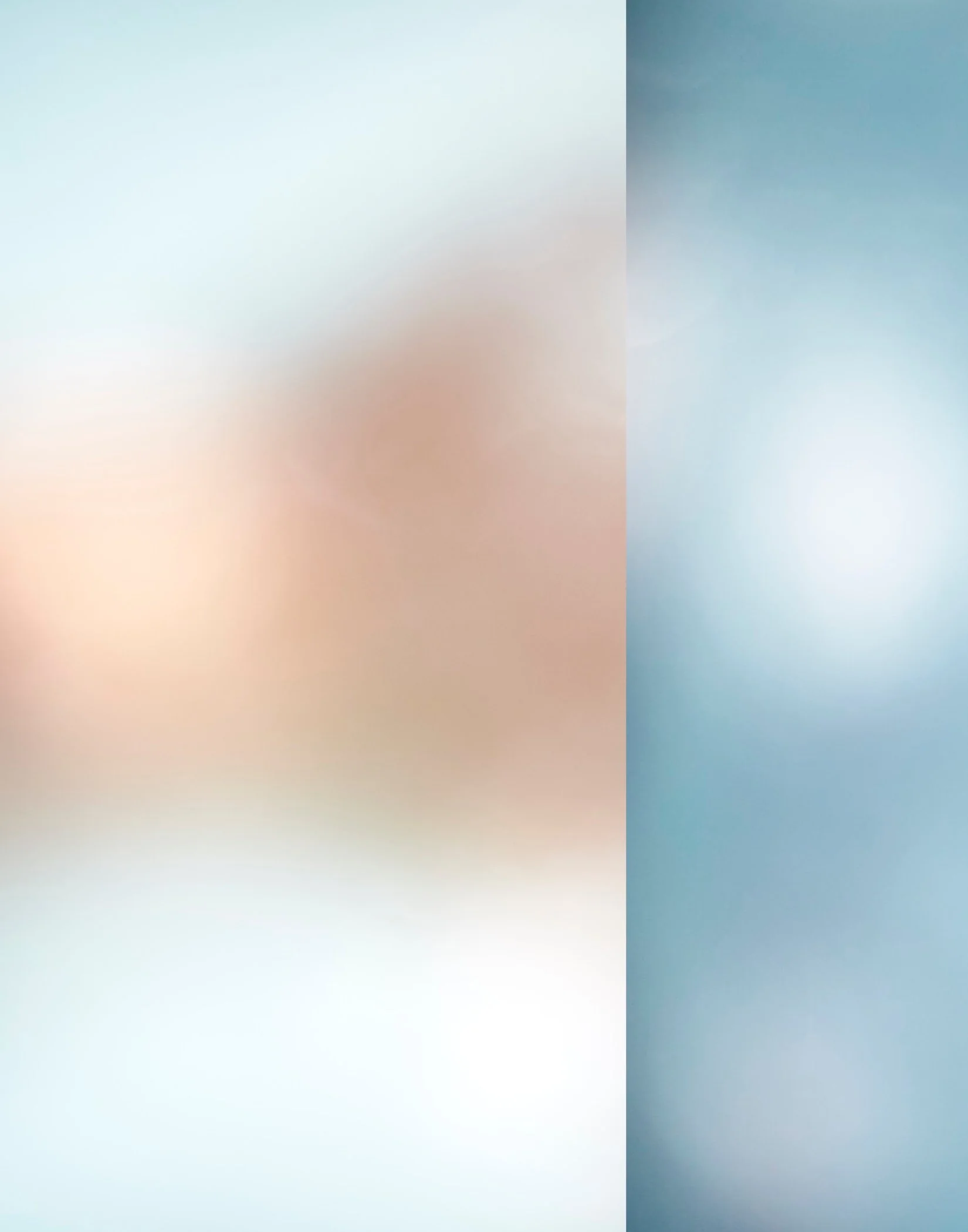 Abstract blurred background with a gradient transition from light pastel shades on the left to darker shades on the right.