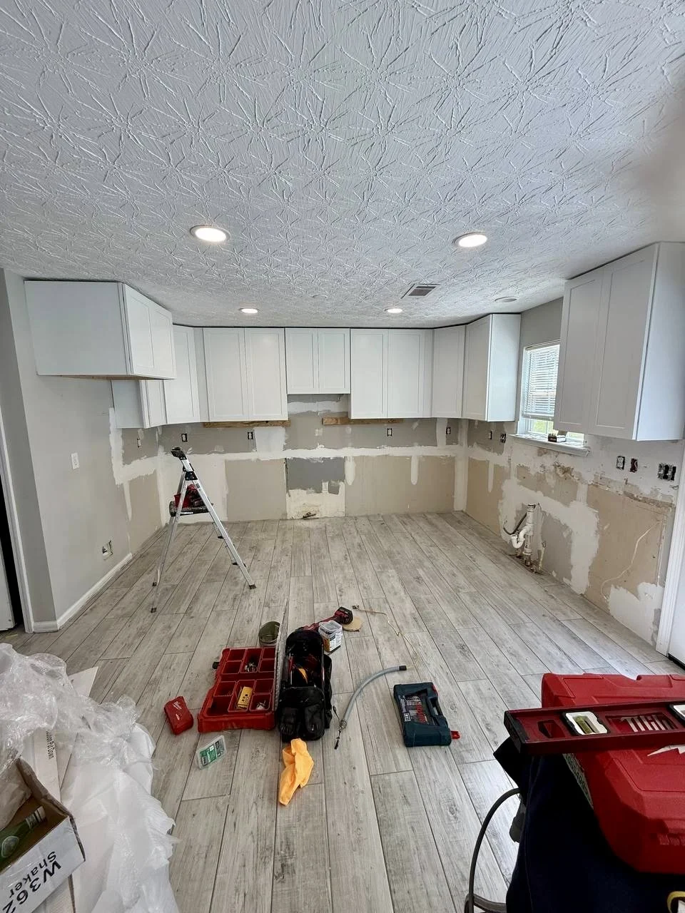 New white shaker-style cabinets installed as part of a full kitchen renovation.
