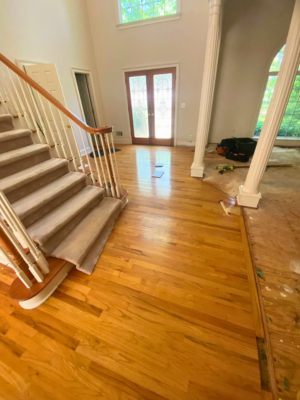 Existing flooring removed and the space prepared for new hardwood installation as part of a larger home flooring renovation.