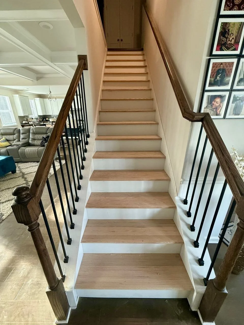 New natural wood stair treads paired with crisp white risers and existing dark wood railings for a clean, updated staircase.