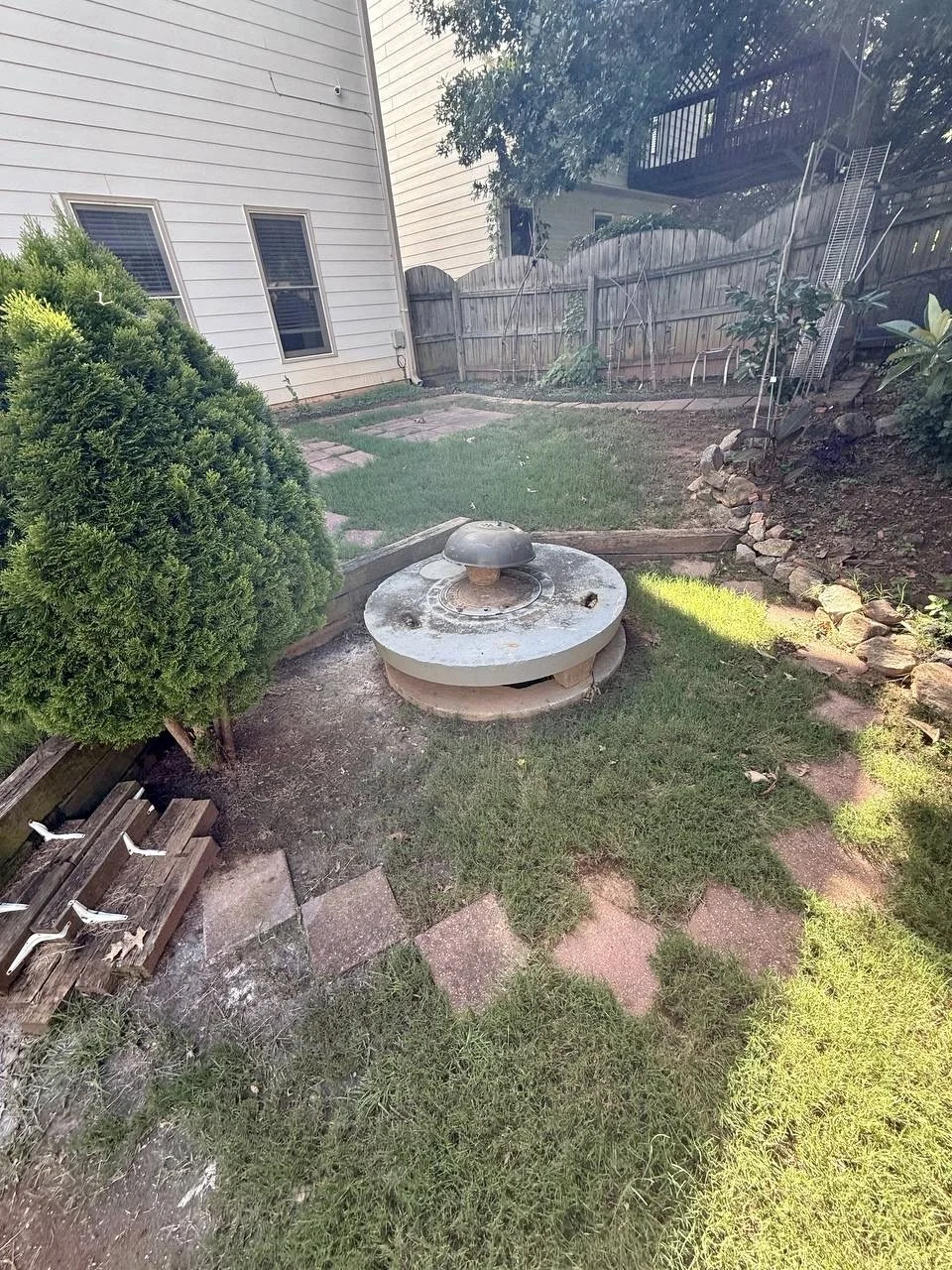 Before view of the existing backyard fire pit area prior to construction of the new surrounding wood platform.