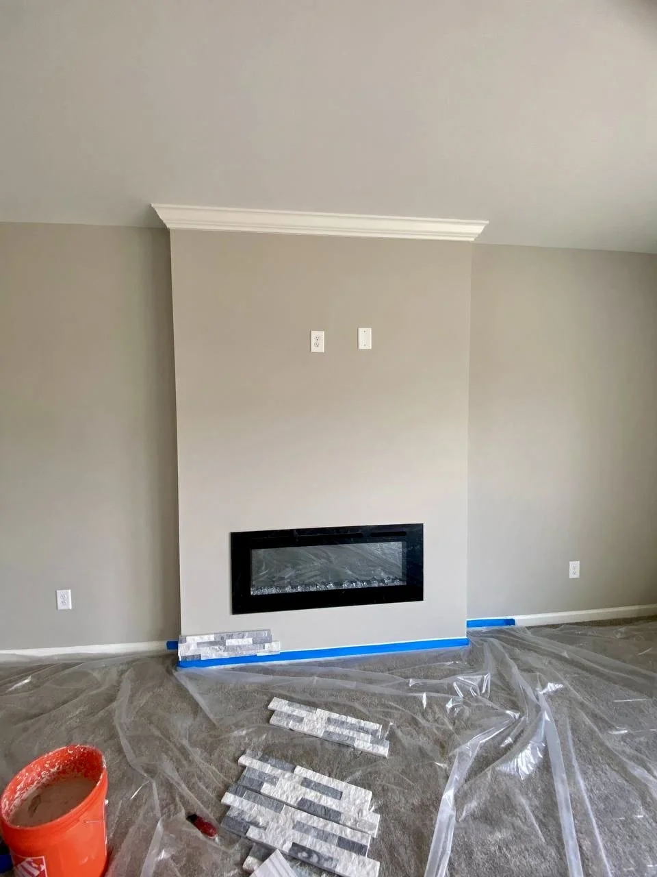 Sleek recessed electric fireplace installed within a custom floor-to-ceiling feature wall.