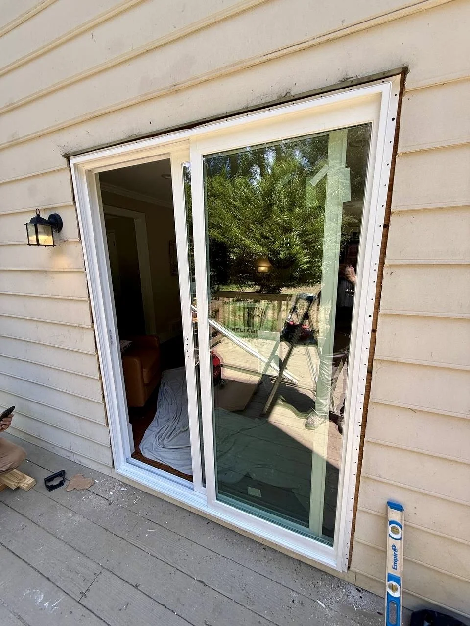 New sliding glass patio door installed to provide easy outdoor access and bring more natural light into the home.