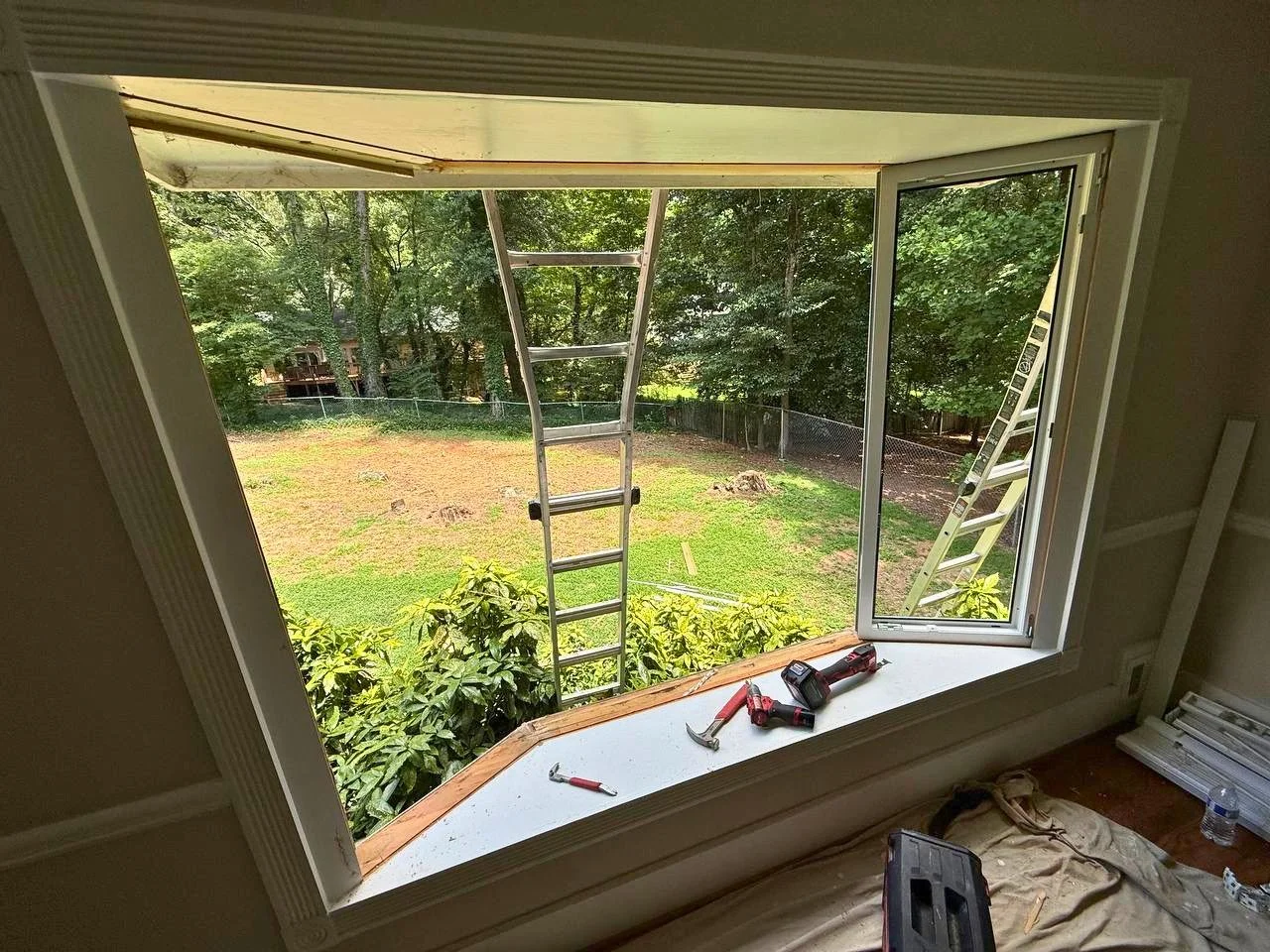Existing window removed and opening prepared for installation of a new bay window system.