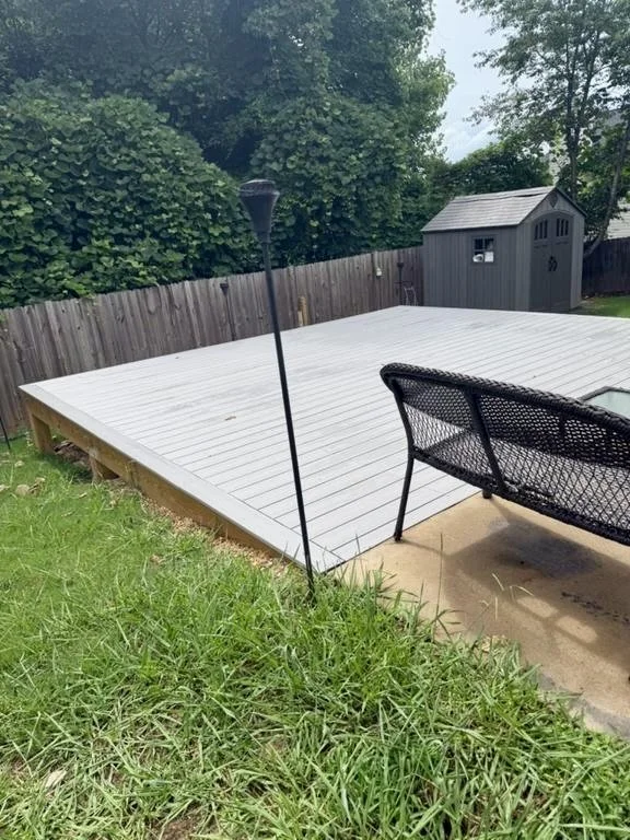 Low-profile backyard deck built to create a spacious, level area for outdoor seating, entertaining, and relaxation.