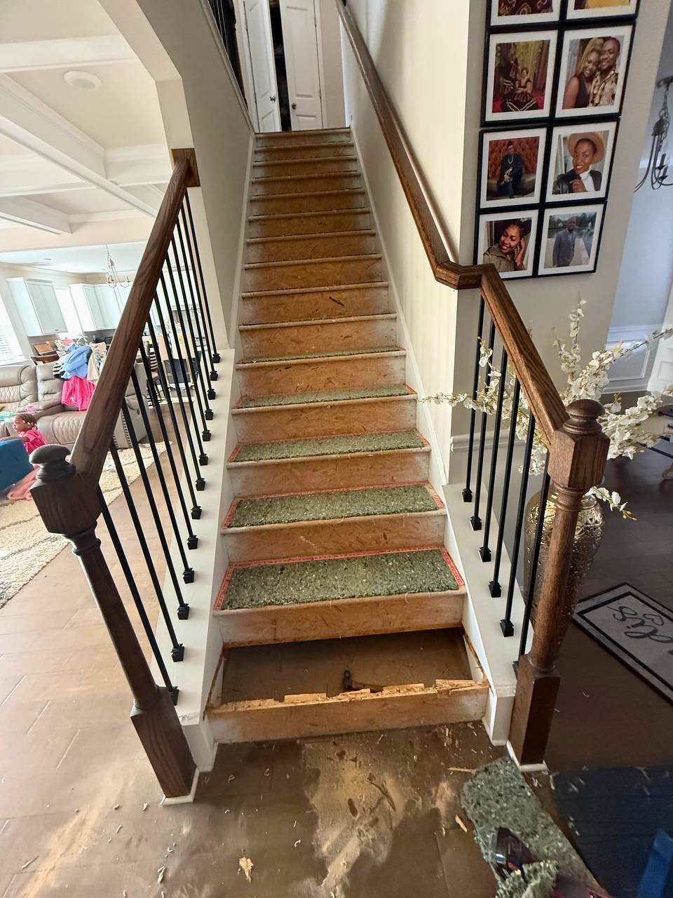 New wood stair treads installed alongside existing railings as part of a complete staircase flooring upgrade.