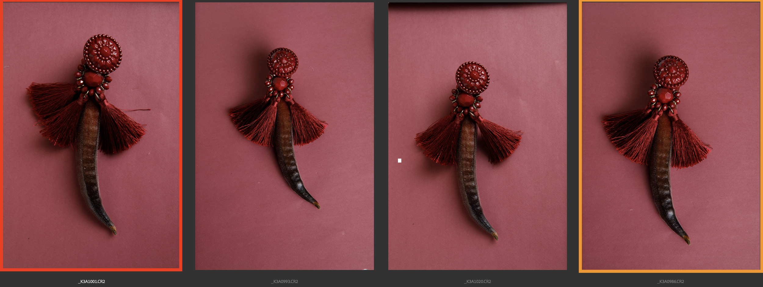 Close-up of a red tassel earring and red okra, set against a red background.