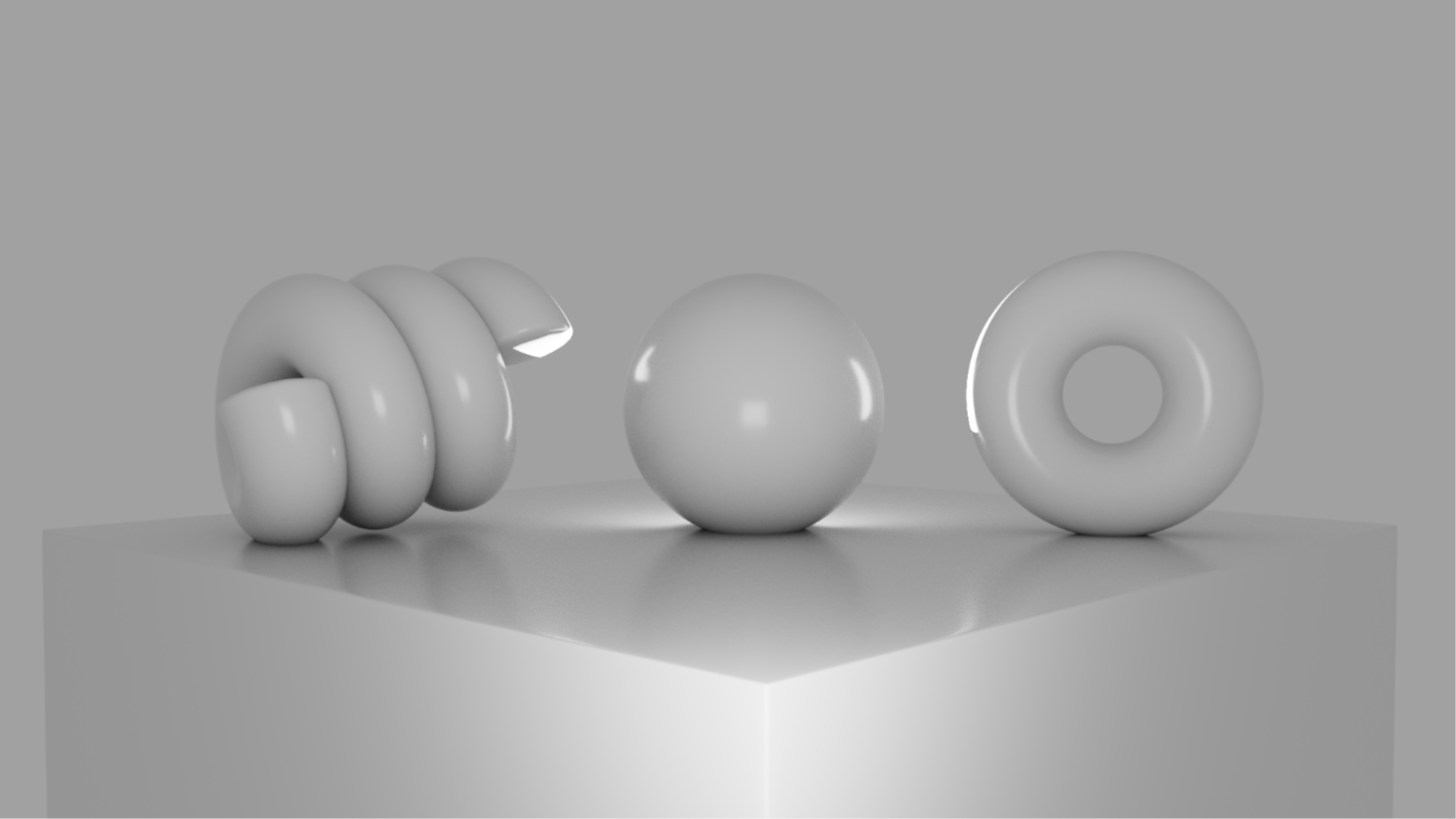 Three gray geometric shapes with a white light on a gray platform against a gray background.