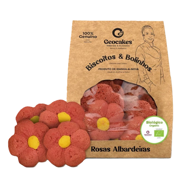 Caixa de biscoitos em forma de rosas alardeiras, com algumas ao lado, com embalagem de papel pardo rotulada como orgânica e natural, com uma ilustração de uma mulher e selo de certificação biológica.