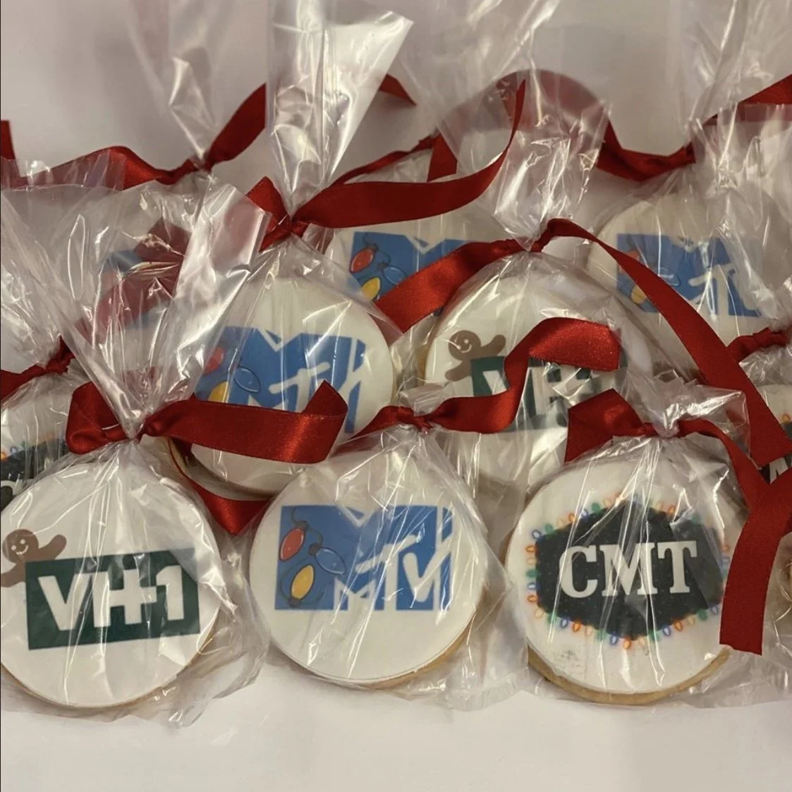 Cookies decorated with logos of VH1, MTV, and CMT, wrapped in clear plastic with red ribbons.
