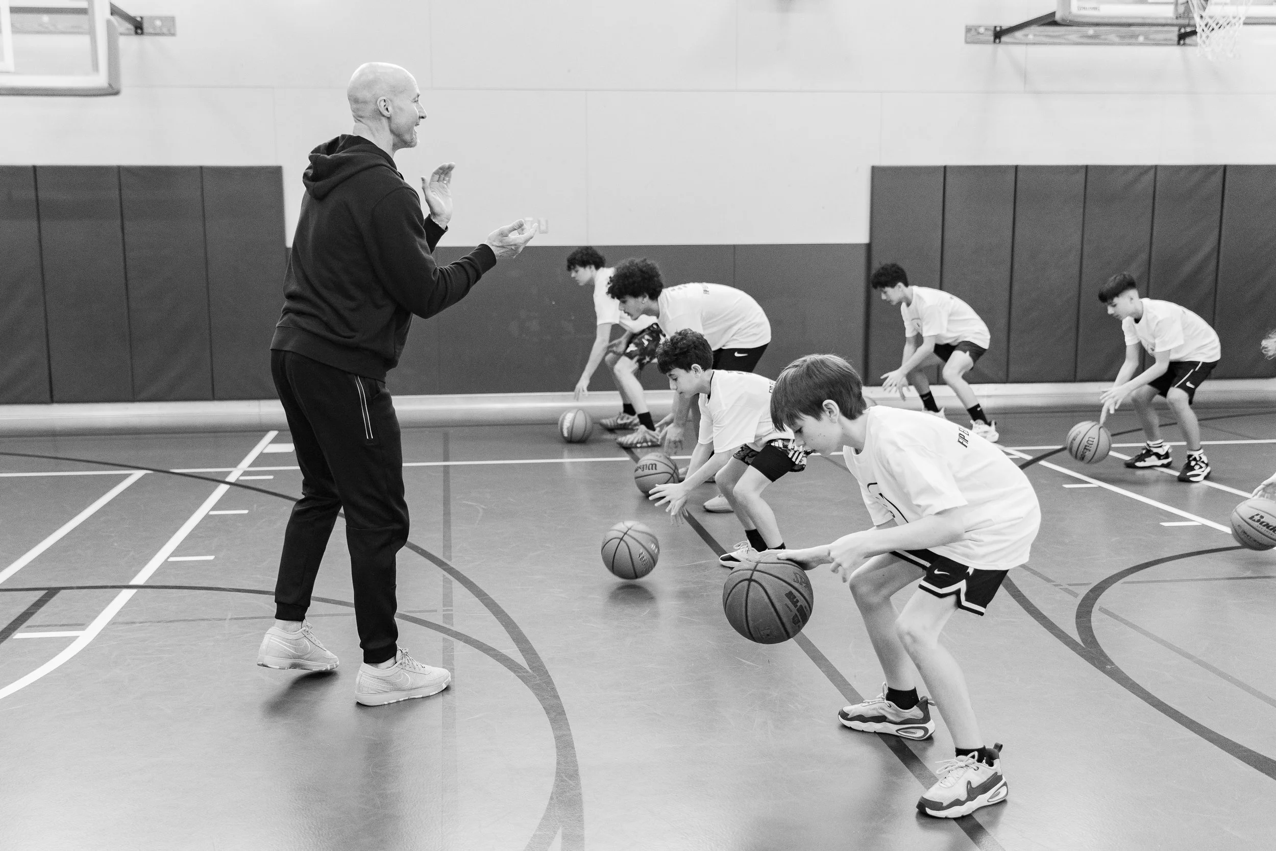 Young basketball athletes practicing basketball training drills