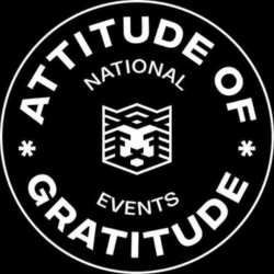 Circular black and white emblem with the text 'Attitude of Gratitude' and 'National Events,' featuring a central stylized lion face graphic.