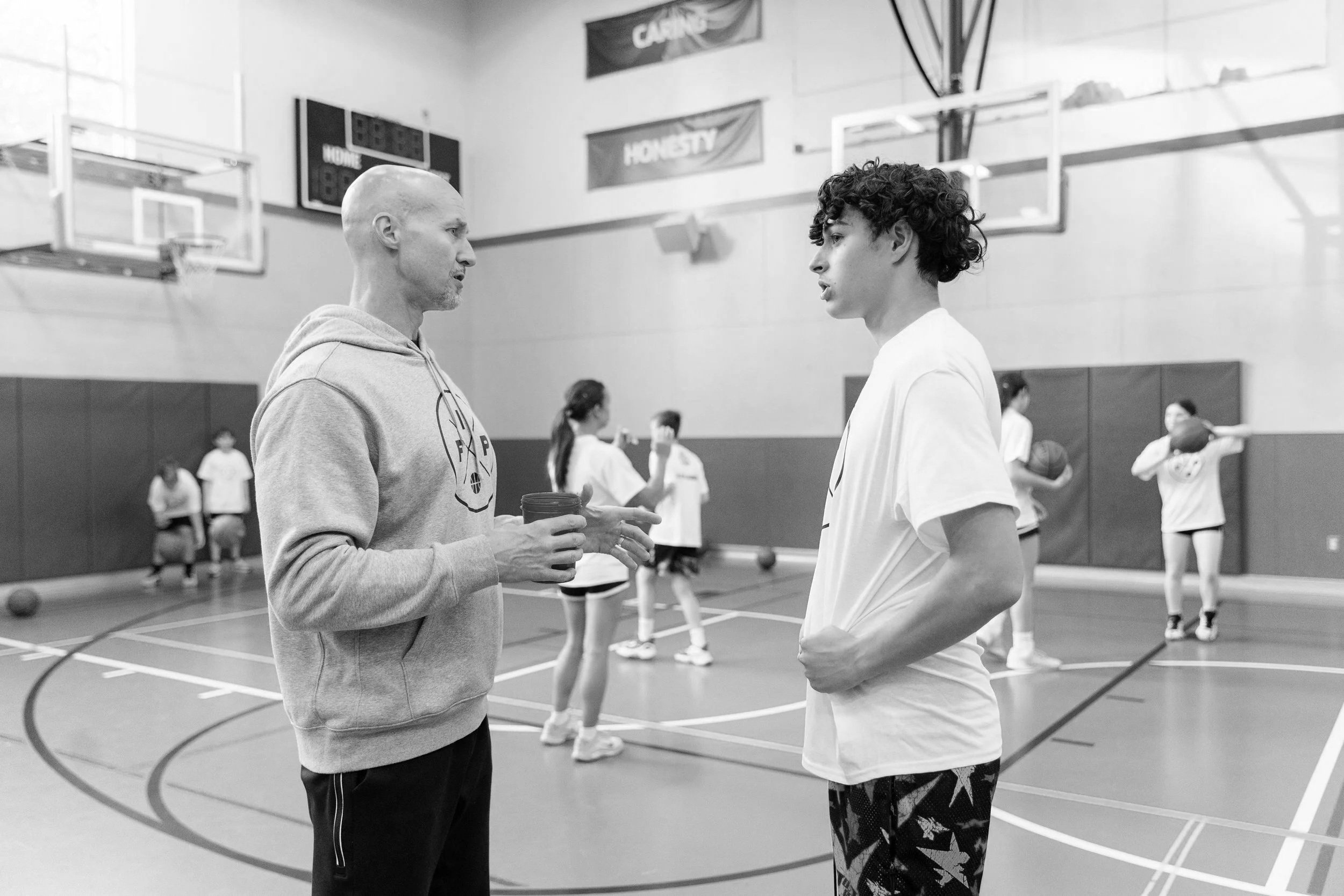 Young athlete receiving basketball coaching from Coach Gabriel Van Guse