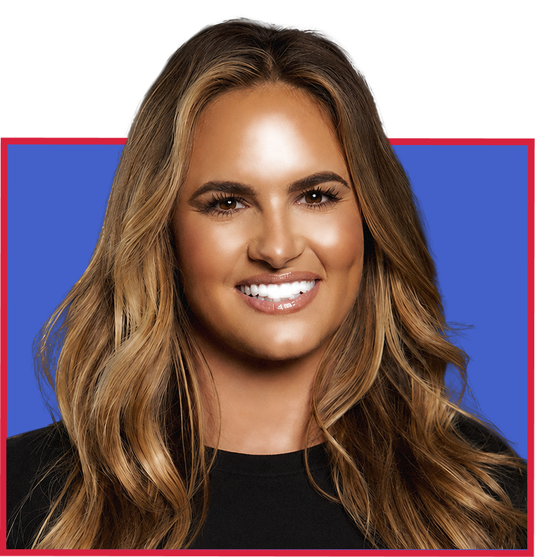 A woman with long, wavy blonde hair smiling against a blue background with a red border.