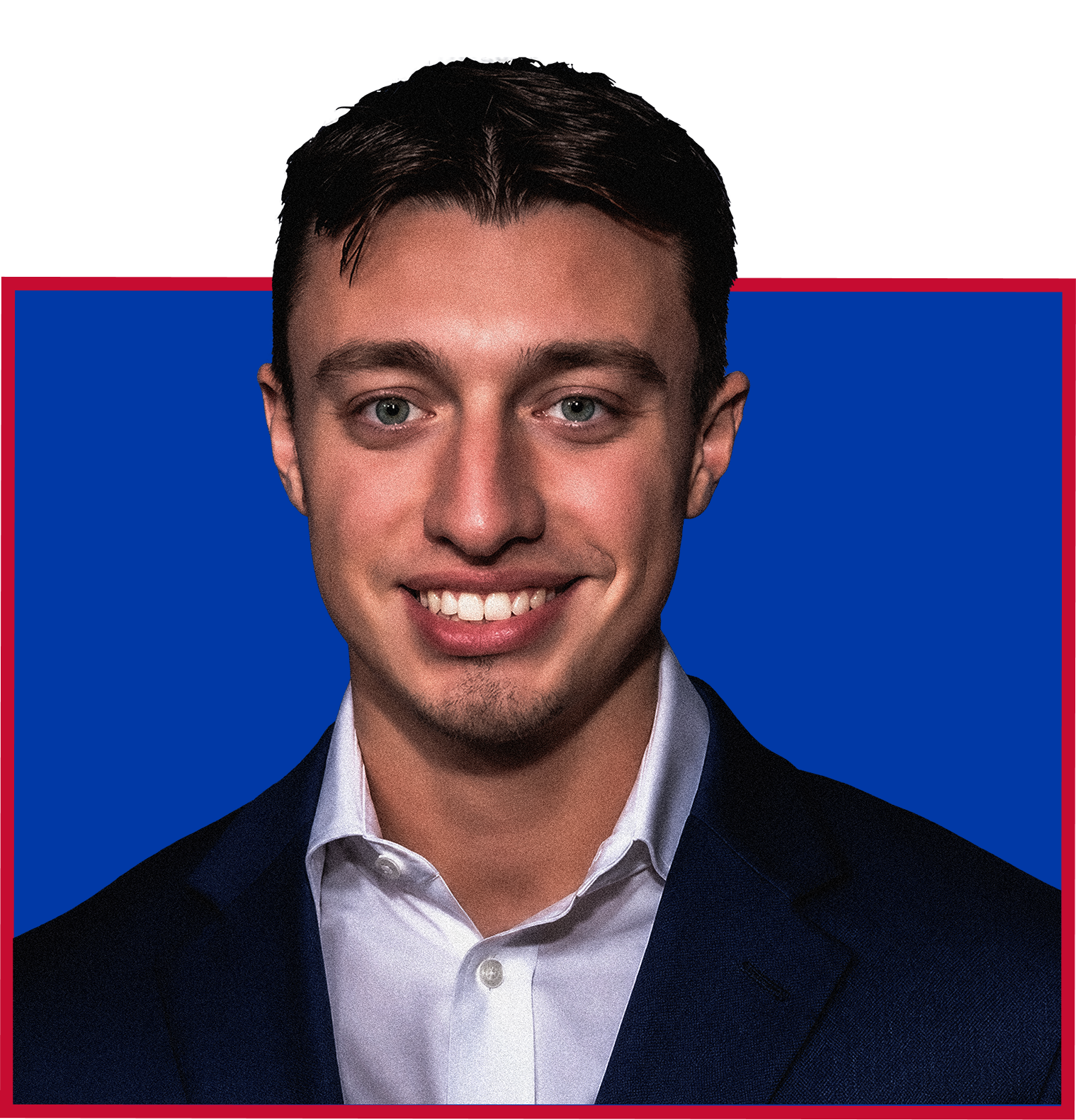 Portrait of a young man with short dark hair, wearing a white shirt and dark suit, smiling, with a blue and red background.