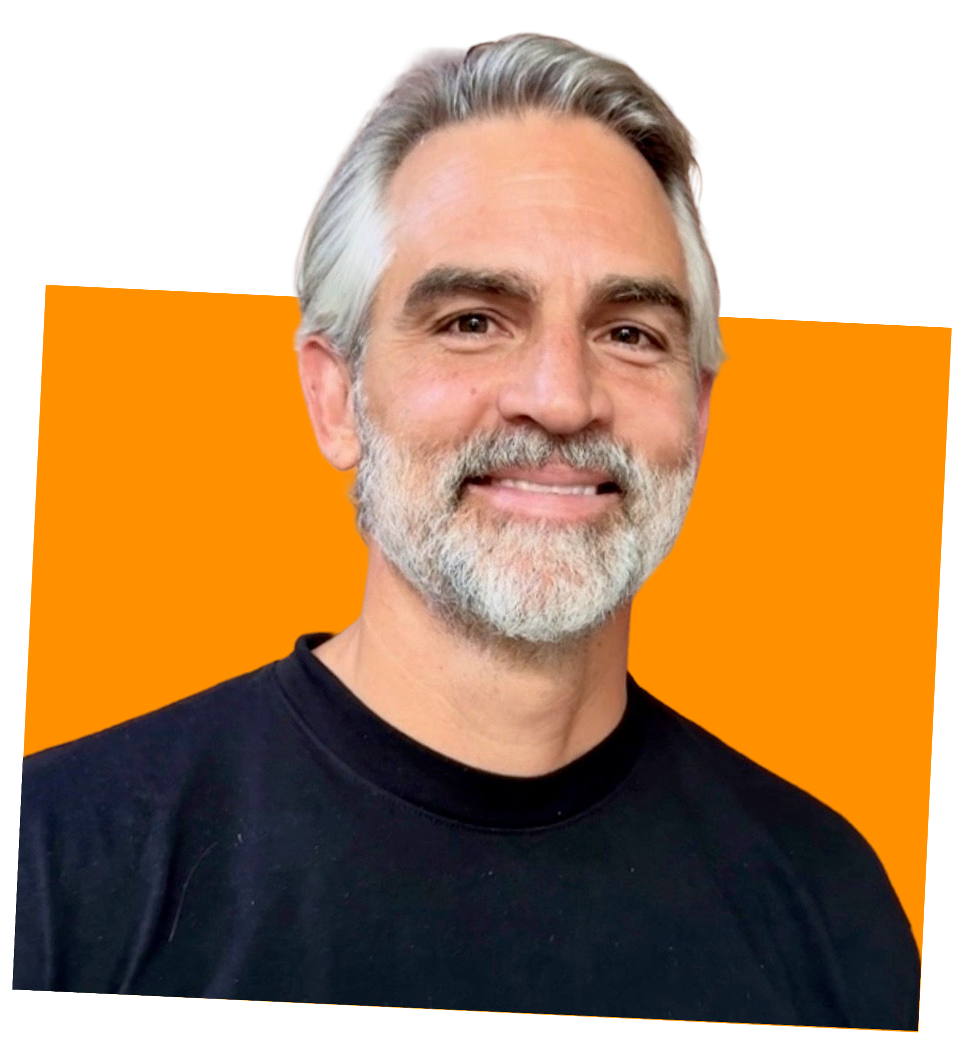 Close-up of a smiling middle-aged man with gray hair, beard, wearing a black shirt, against an orange and black background.
