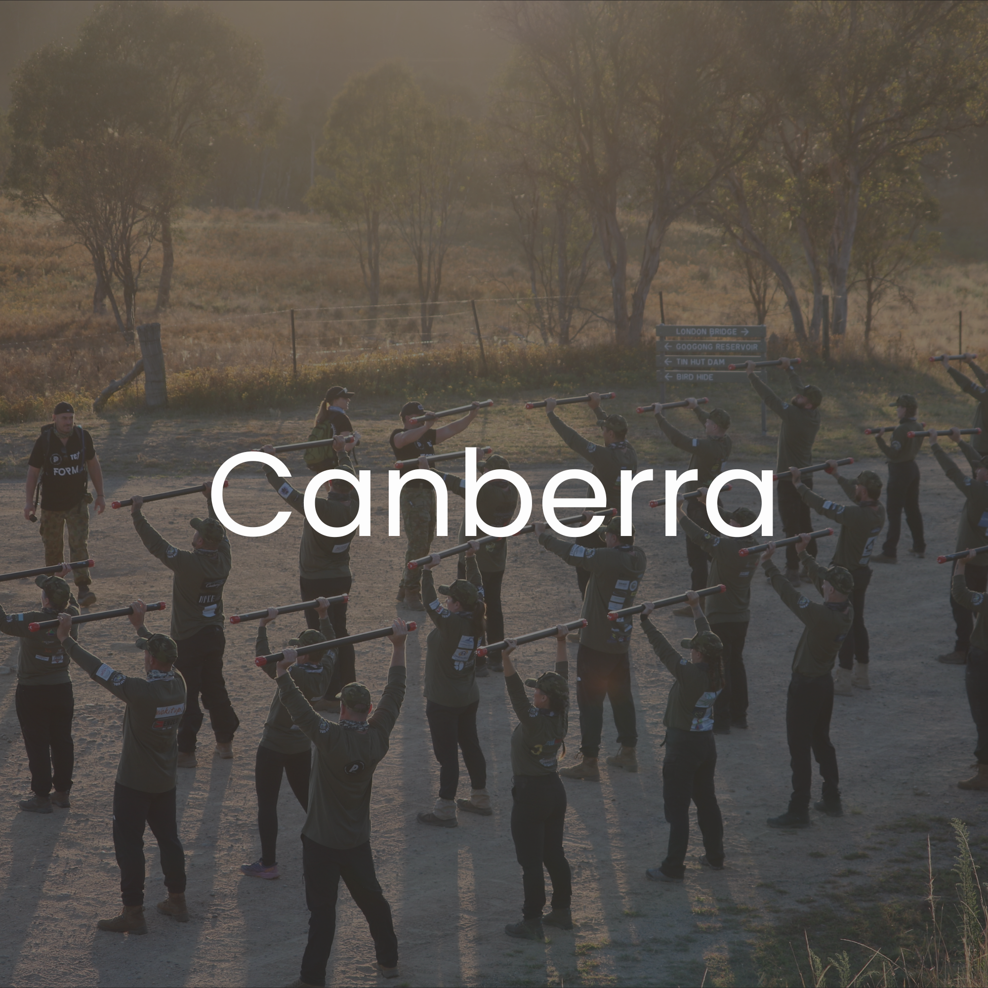 30 Unbroken participants participating in an outdoor training exercise, with trees in the background during sunset.