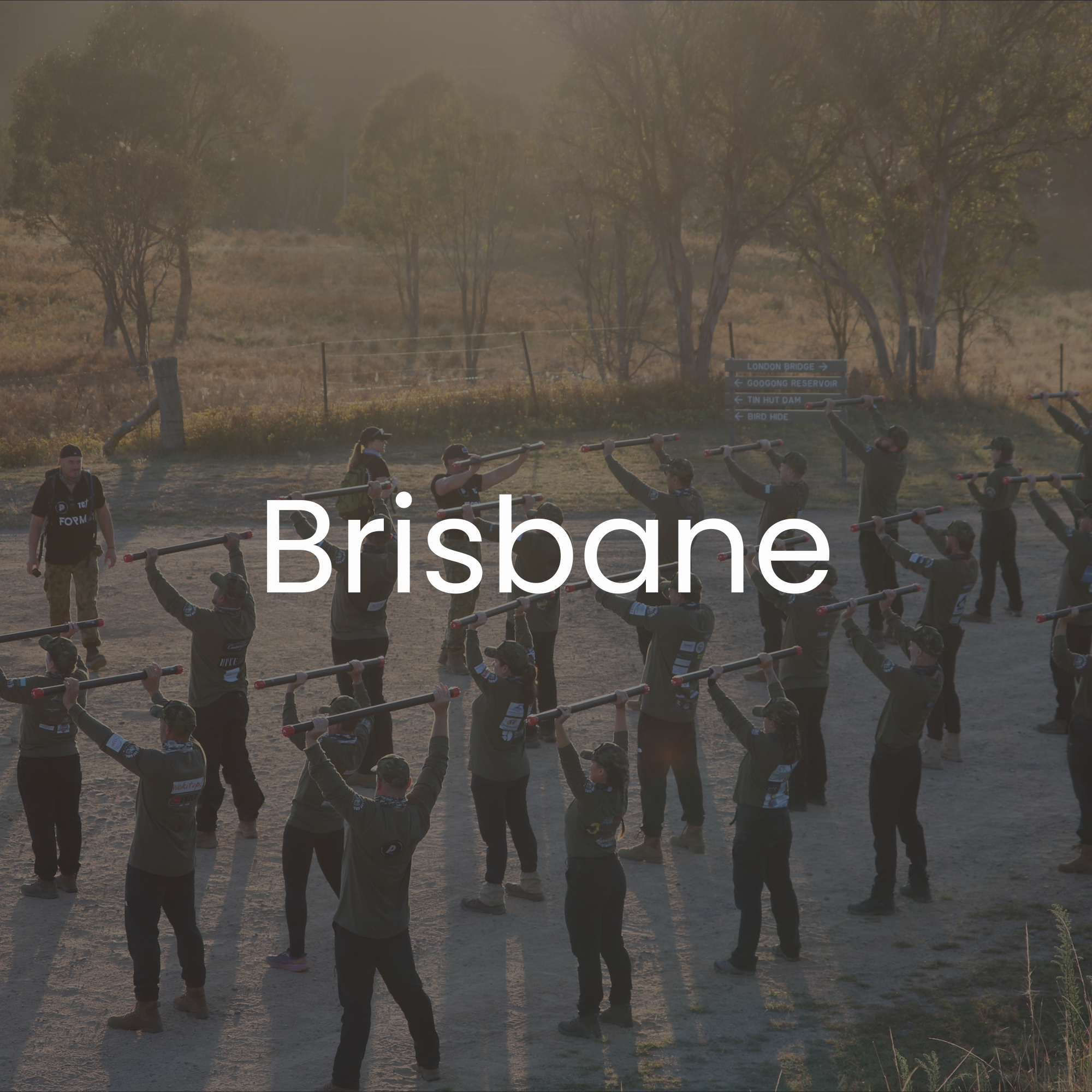 30 Unbroken participants participating in an outdoor training exercise, with trees in the background during sunset.