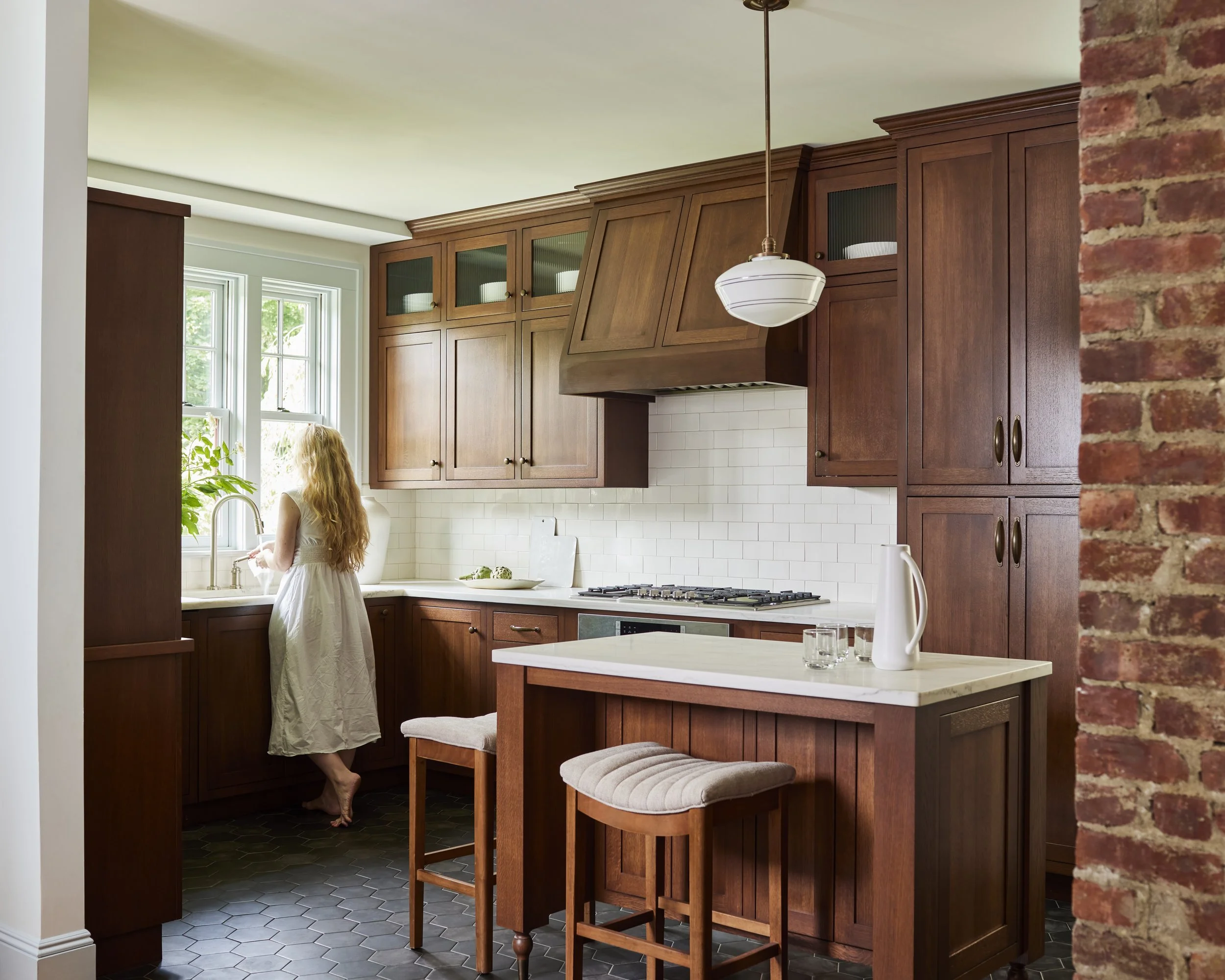 woman standing at sink in custom kitchen