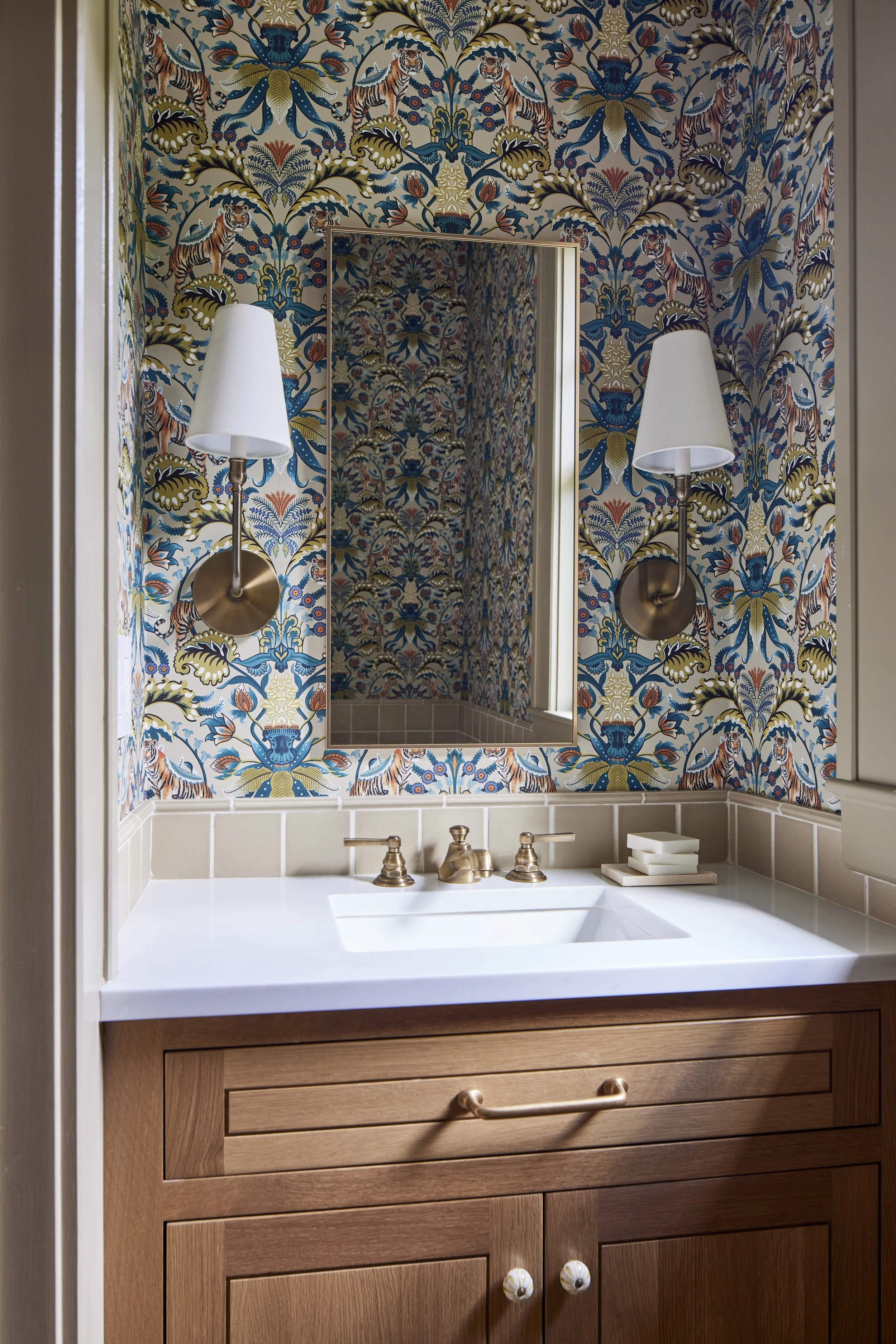 wood sink with white countertop and close up of decorative wallpaper