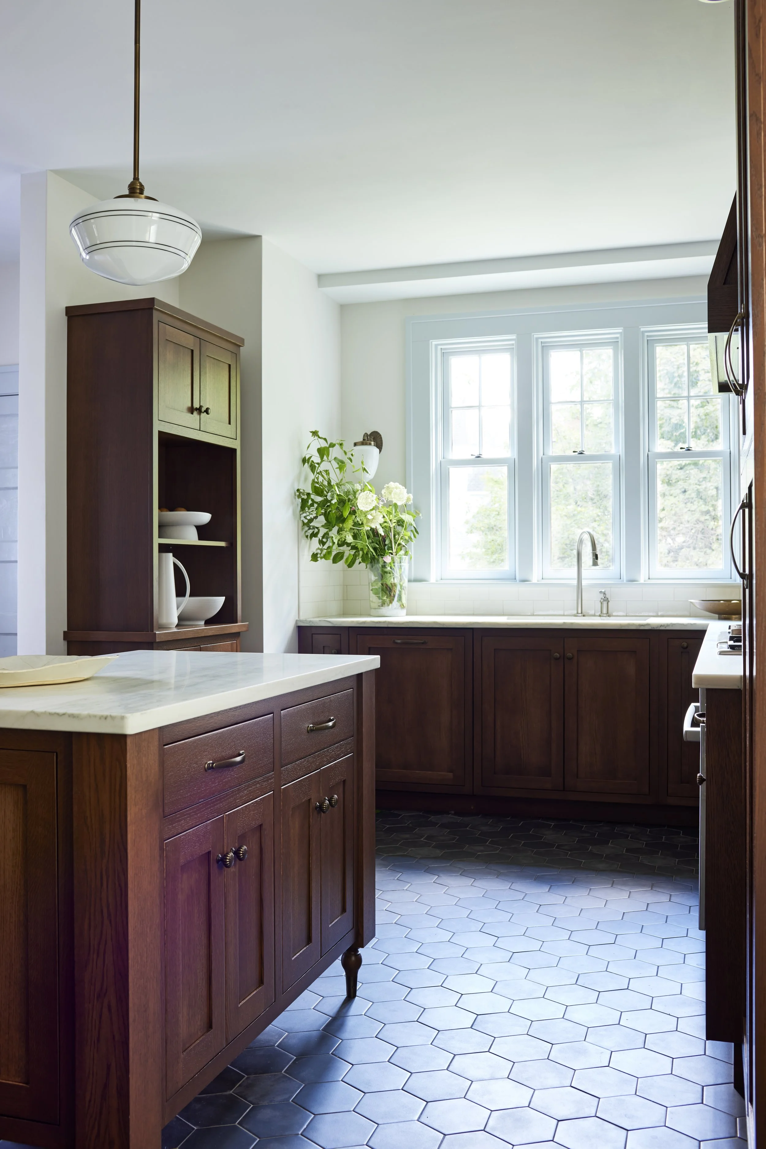 custom kitchen with dark wood cabinets and light colored counter tops and walls