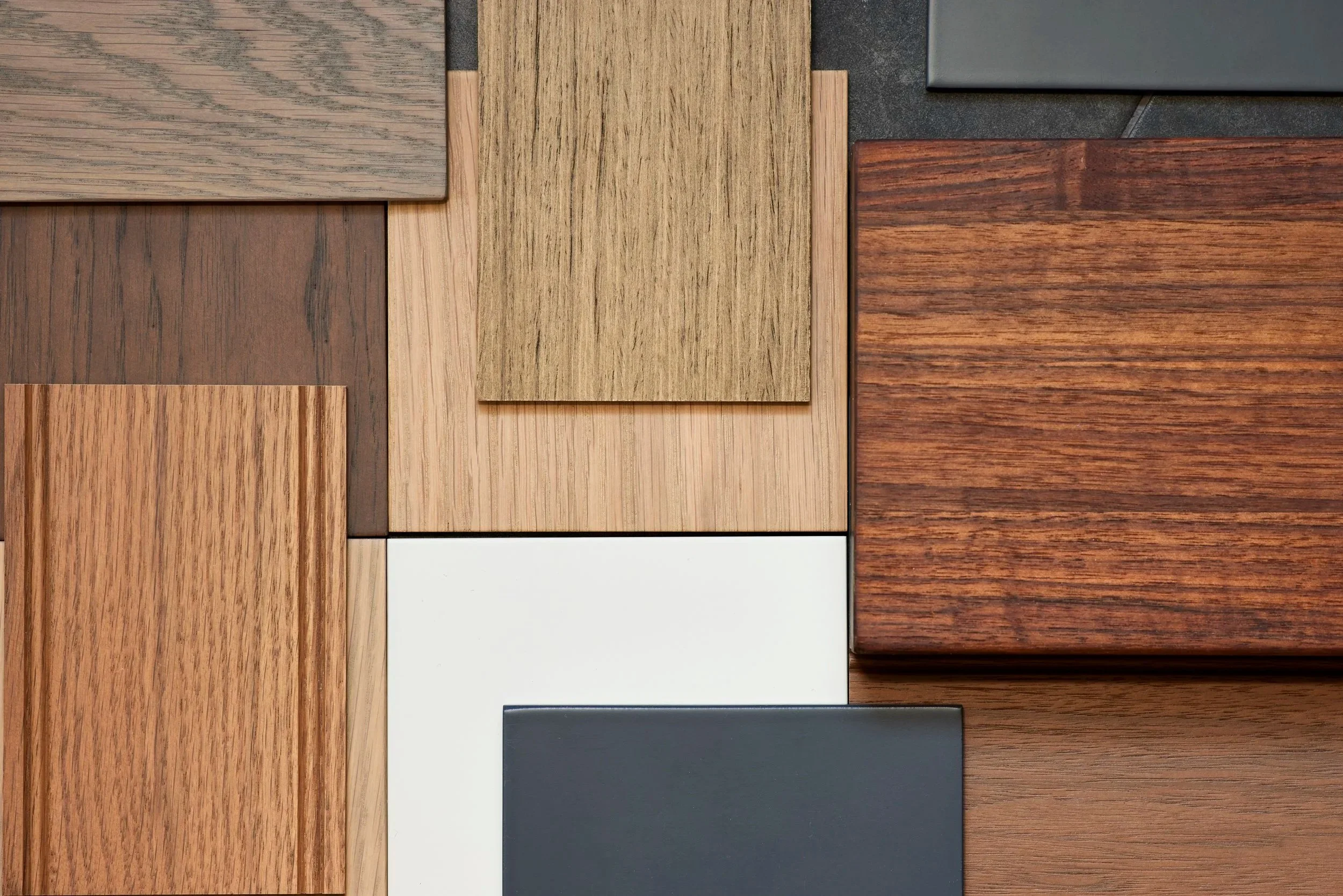 wood sample of varying finishes displayed neatly in a pile