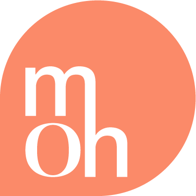 A logo with a peach-colored background and white lowercase letters 'm' 'o' and 'h' inside a circle.