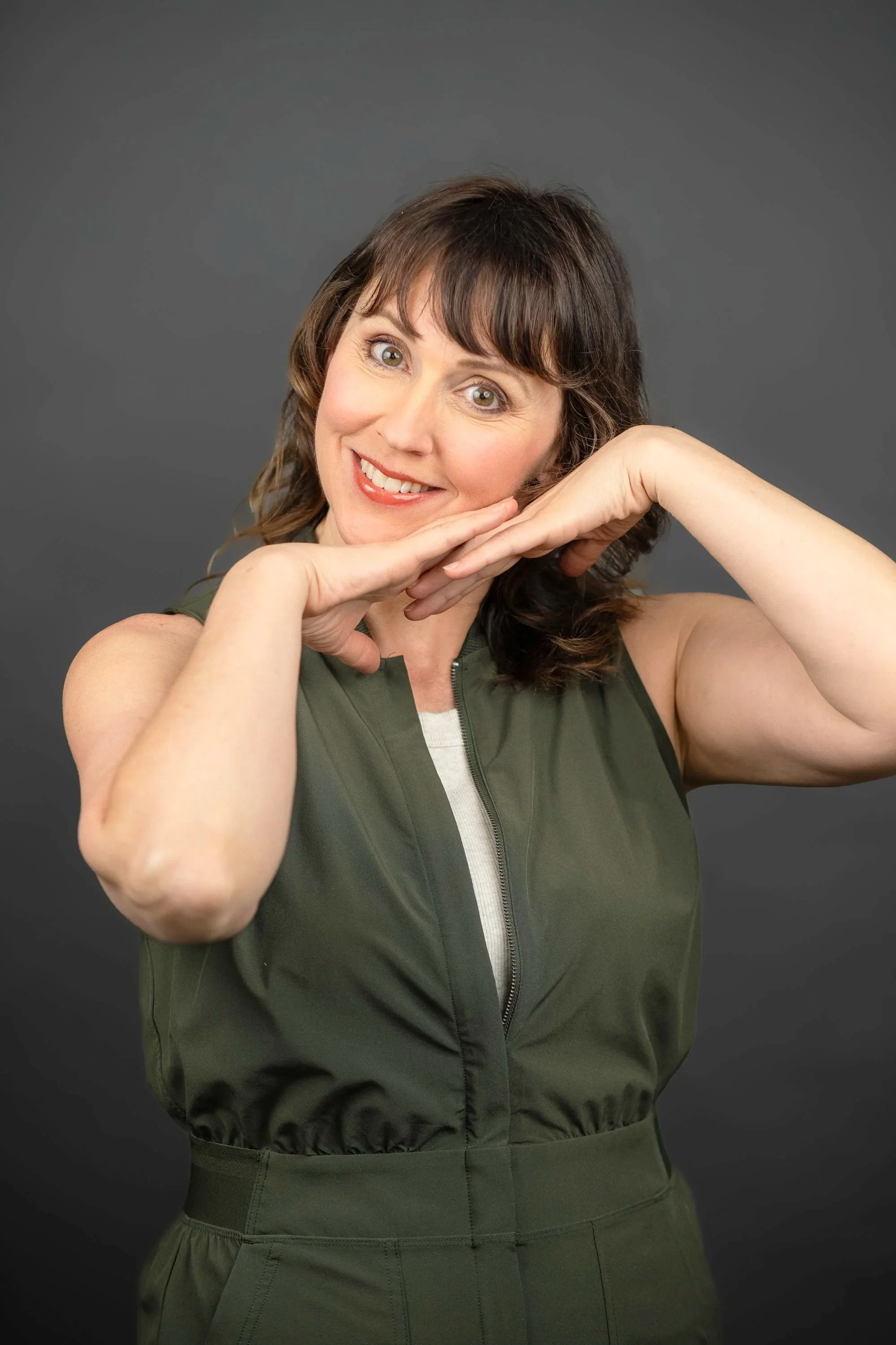Smiling Musical Improviser Leslie Collins Head in hands. Totally Made Up Musical