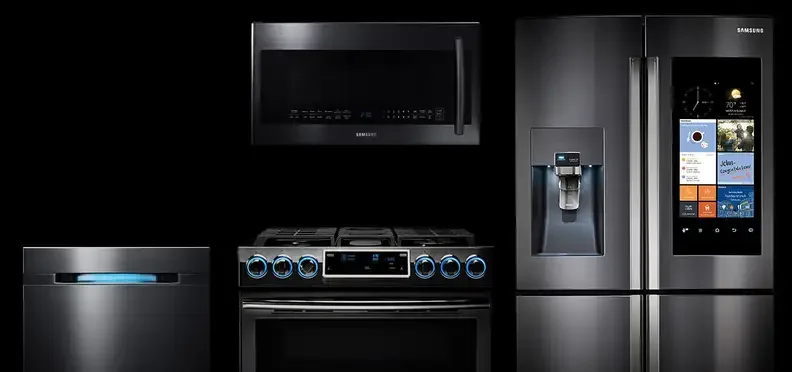 Modern black kitchen appliances including refrigerator, oven, microwave, and dishwasher