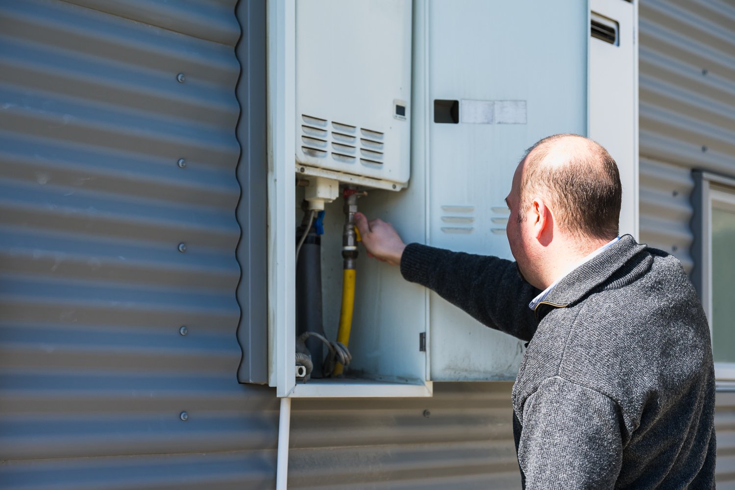 A property manager from Bayleys checking a califont at a commercial property managed by the Queenstown, Wanaka and Cromwell team.