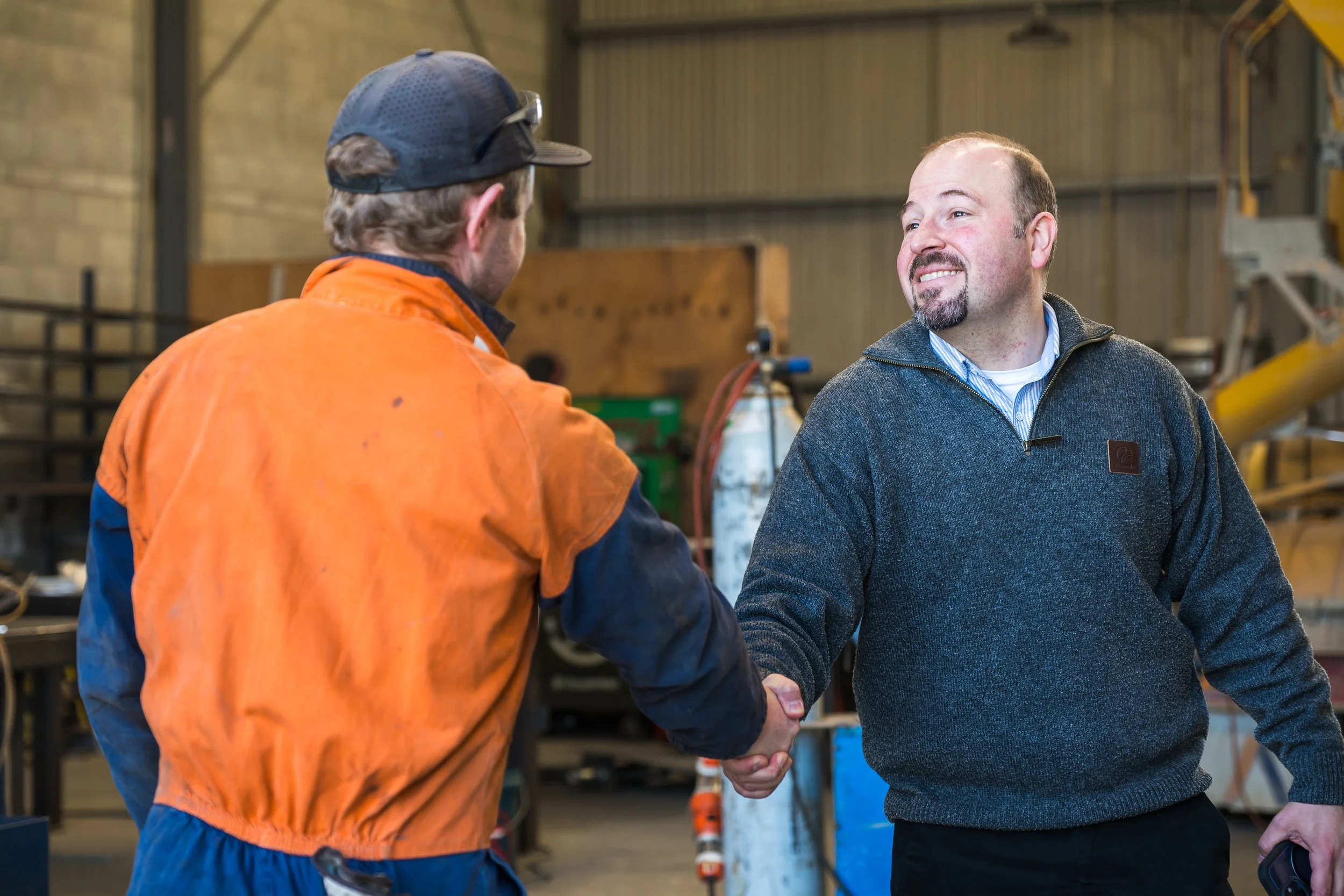 A Bayleys commercial property manager shaking the hand of a tenant at a property check in.