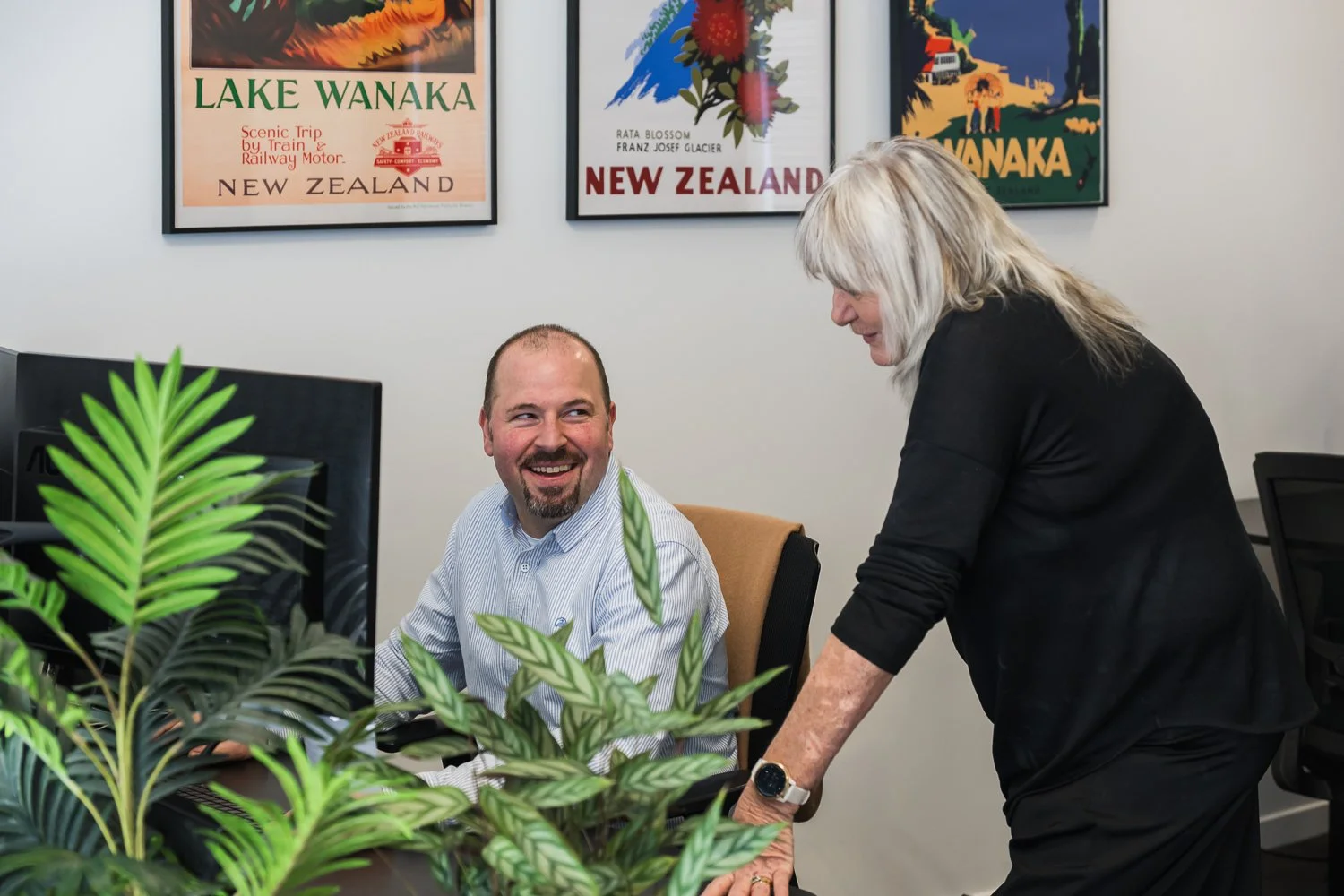 Two of Bayleys commercial property managers talking together in their Southern Lakes office.