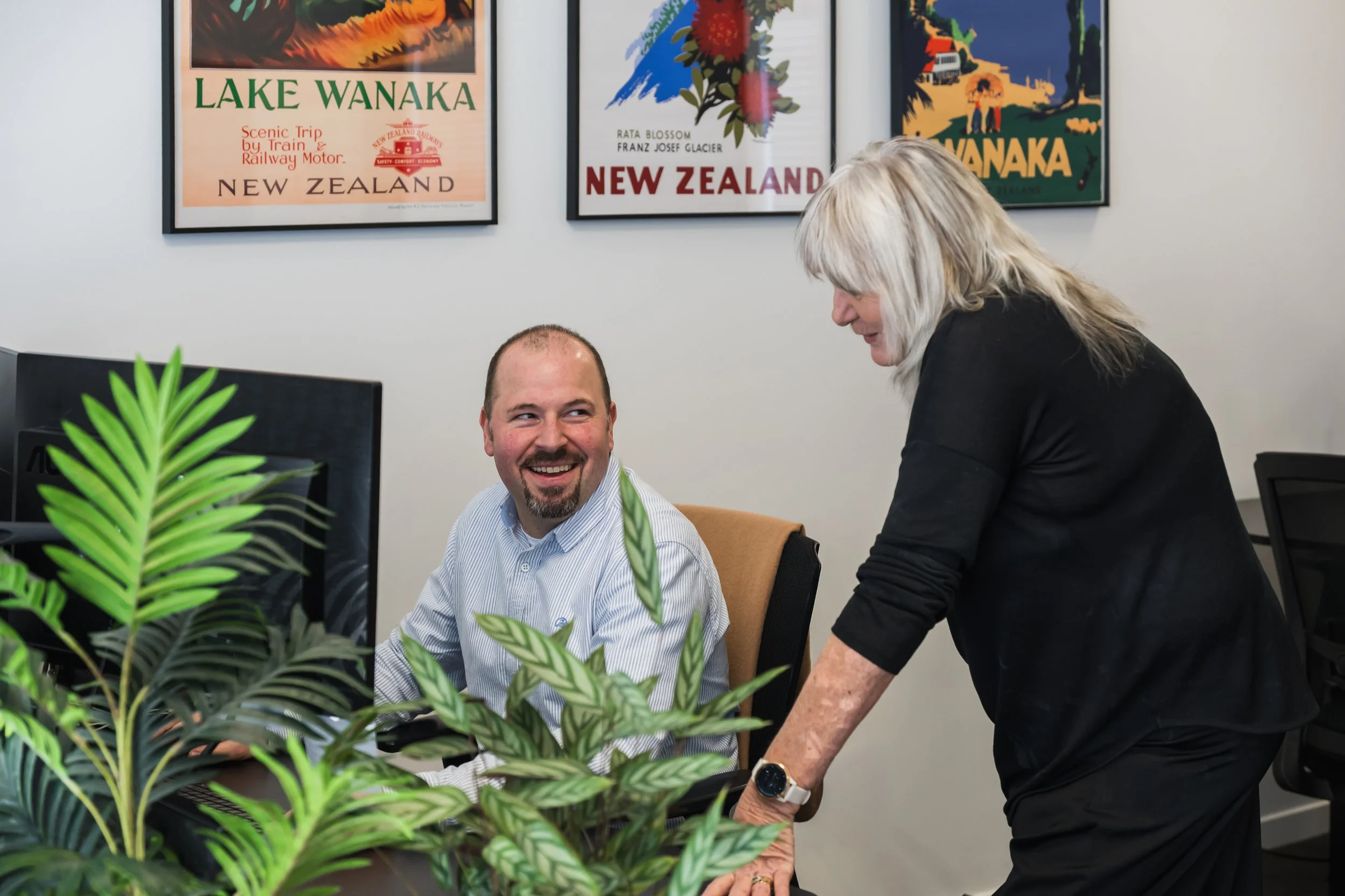 Two of the Bayleys Commercial Property management team talkng together in their Wanaka office.