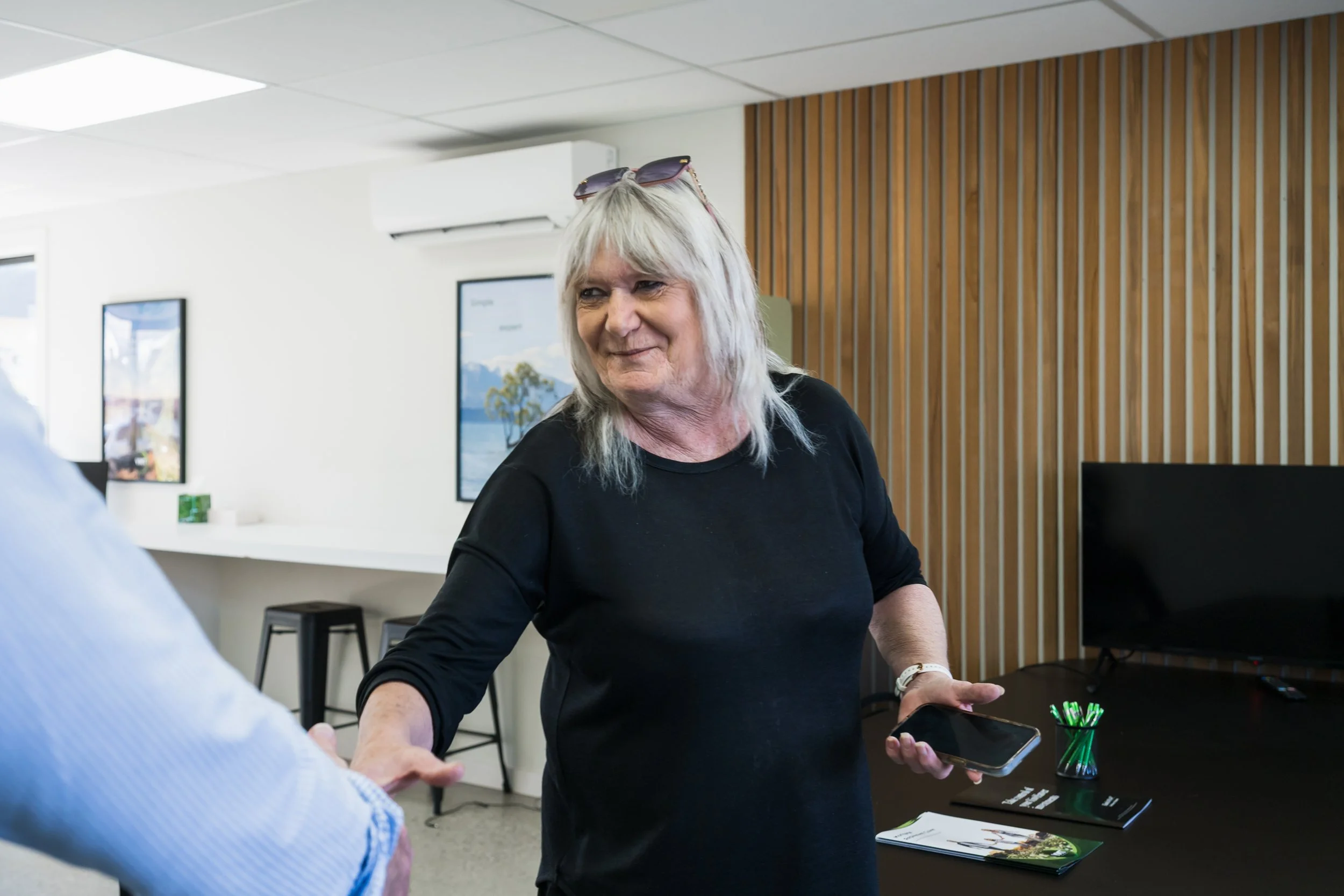 Barbara, a Bayleys Commercial Property Manager in the Wanaka office shaking a clients hand.