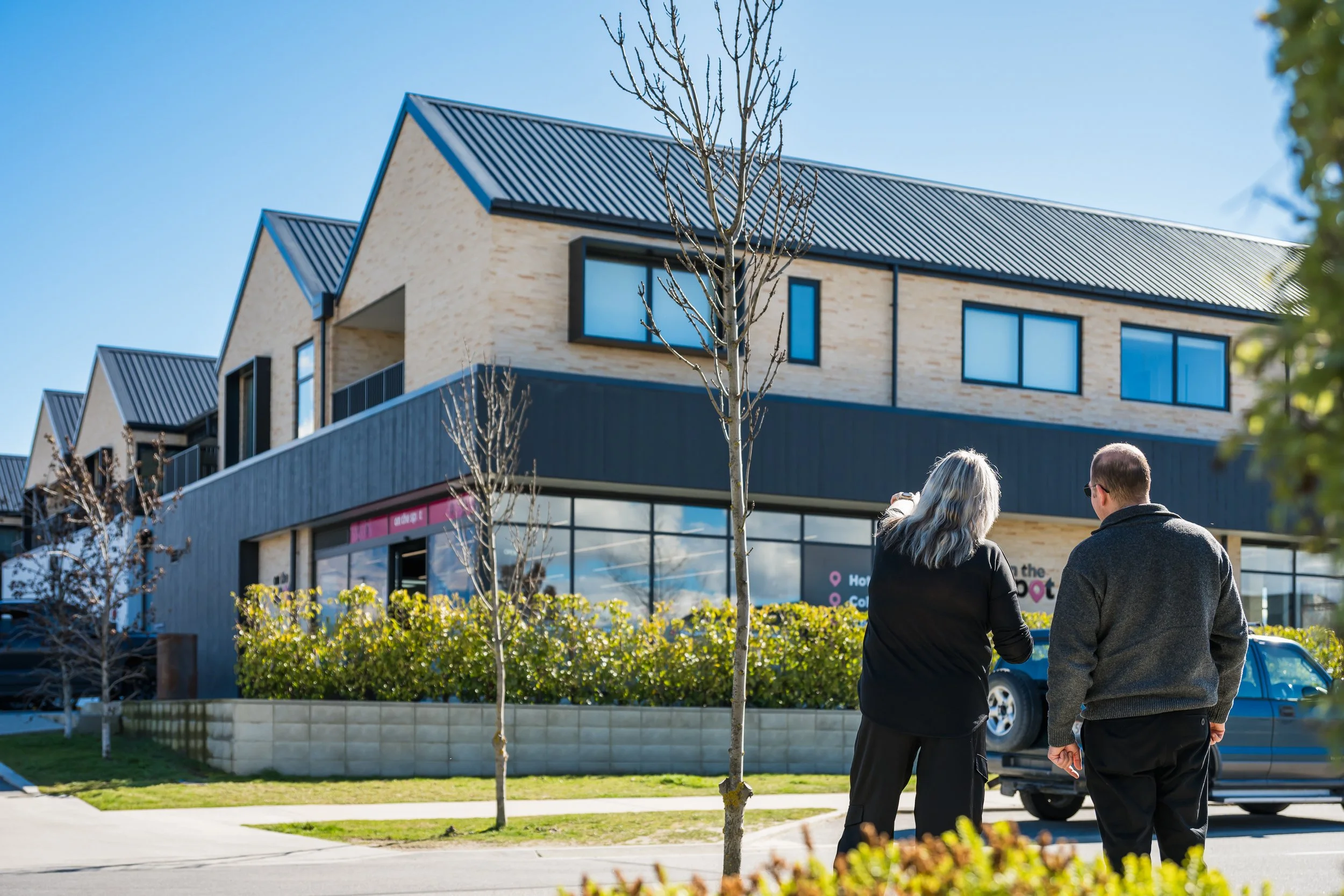 Two of Bayleys Commercial Property managers looking towards the exterior of one of their Wanaka mixed use properties.