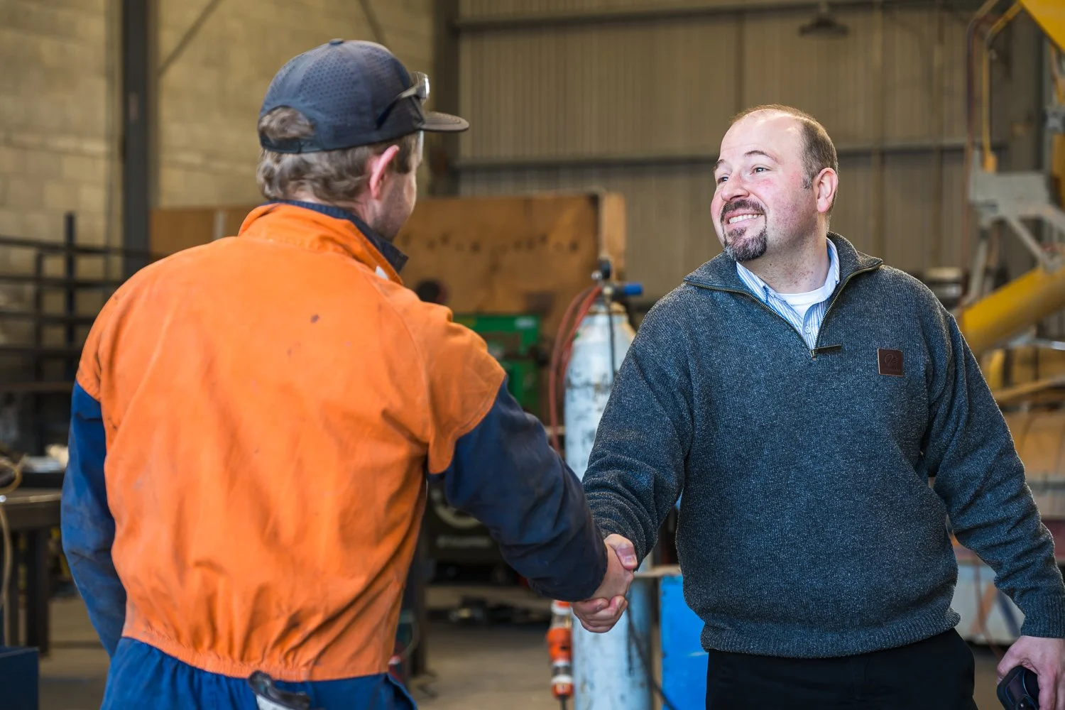 A Bayleys Commercial Property Management team member shaking the hand of a tenant in a property managed by the team.