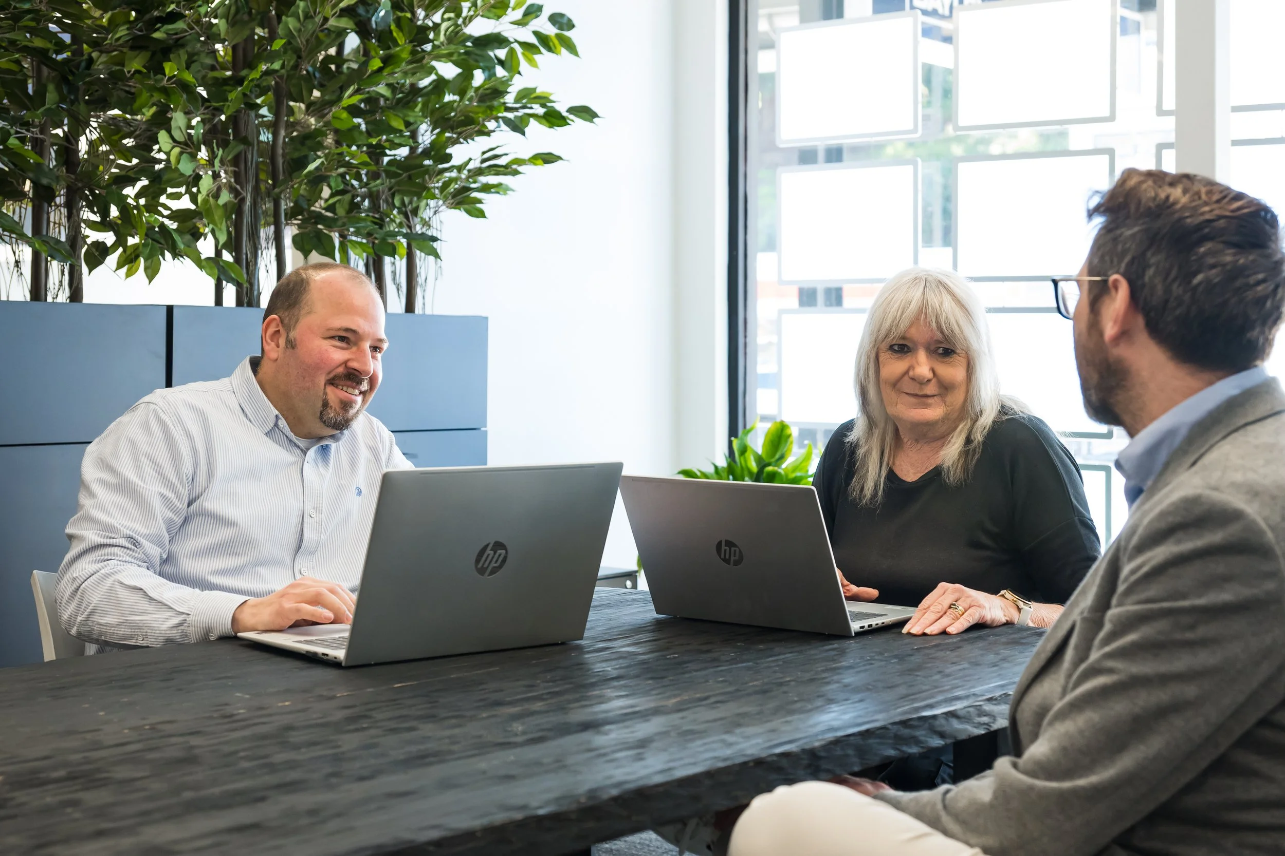 The Bayleys Commercial Property Management team members sitting together at a desk in the Wanaka office.