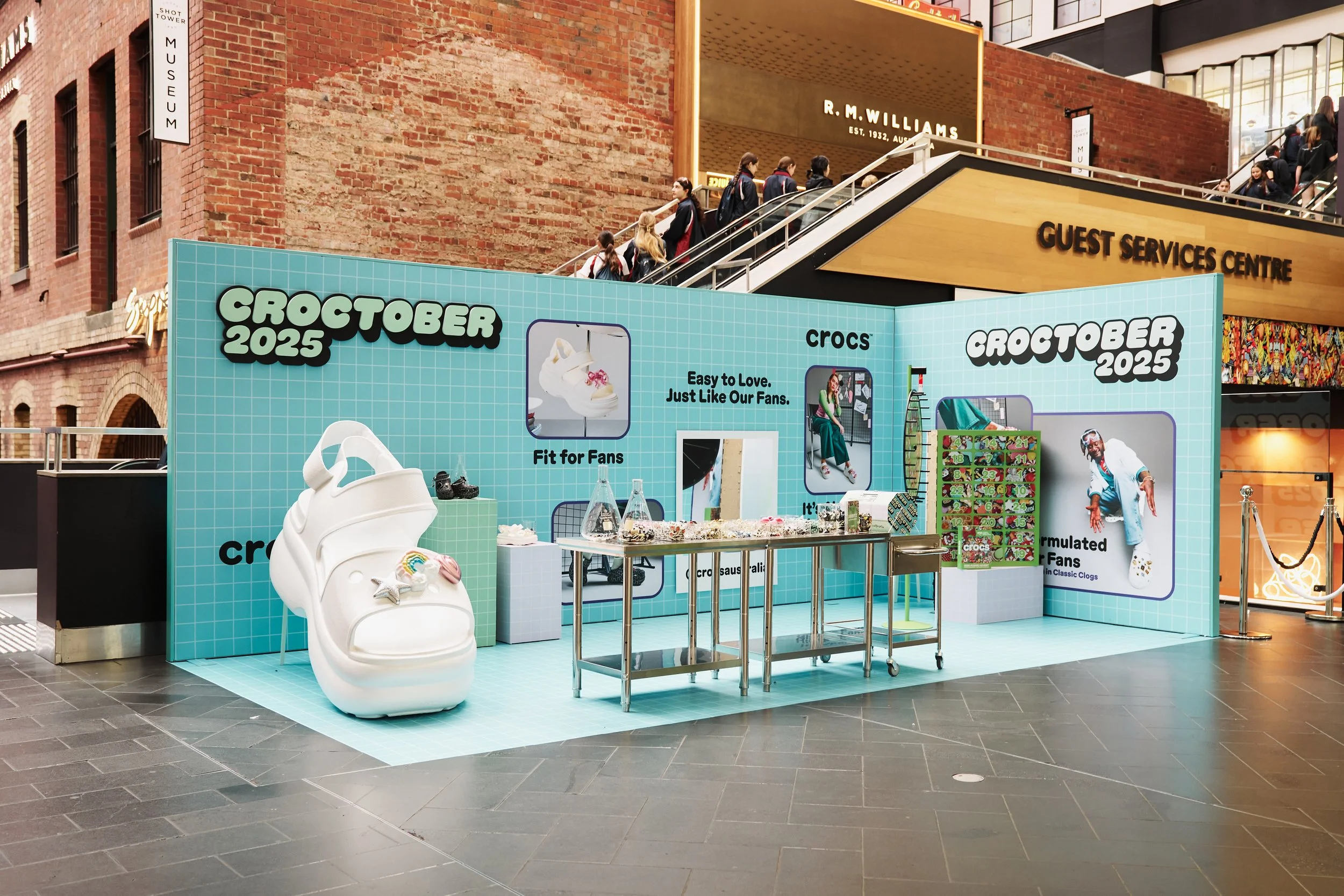 Indoor display promoting Crocs shoes at Croctober 2025 event, featuring various shoe designs, mannequins, and promotional signs in a shopping mall.