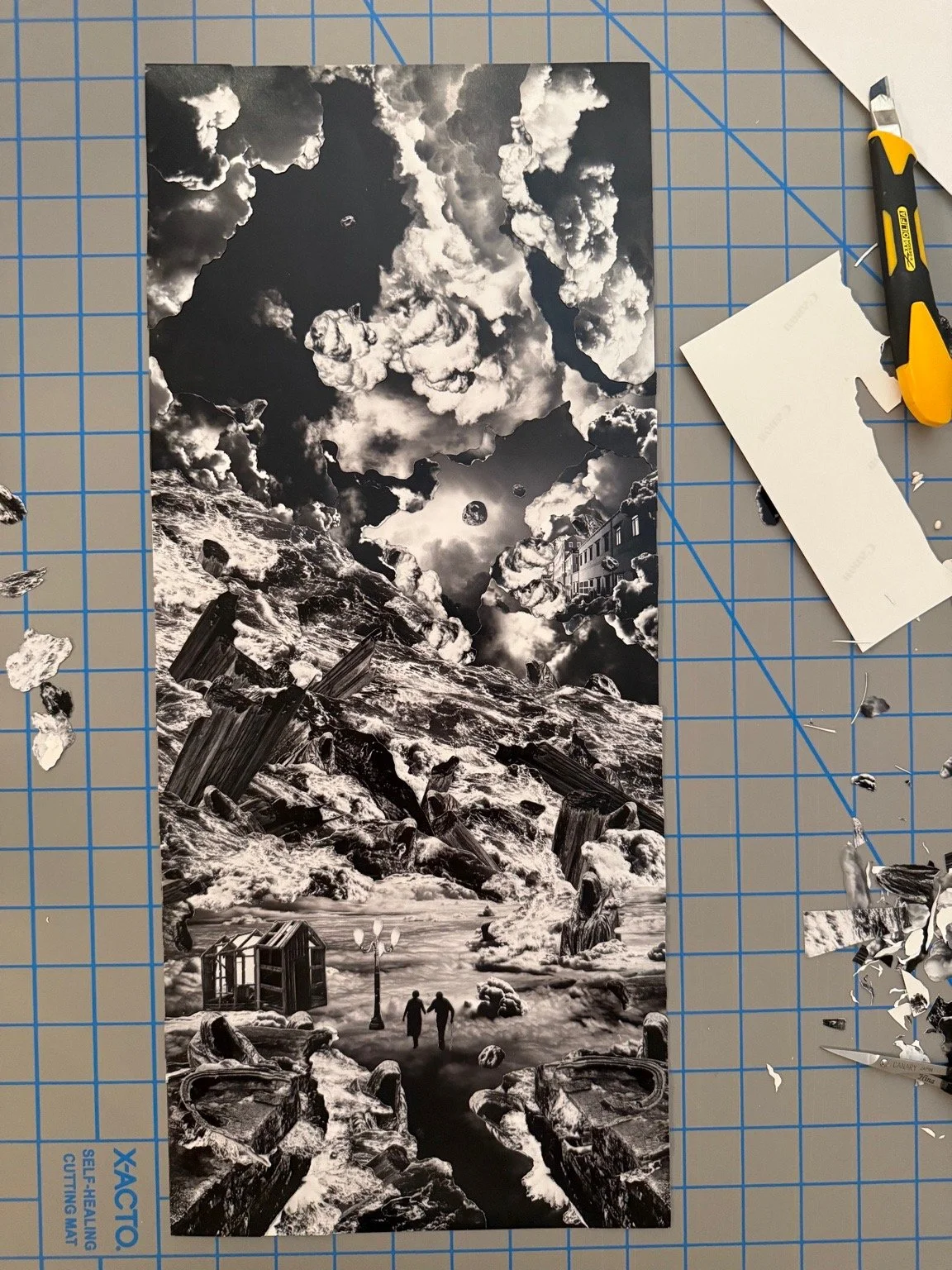 A black and white collage consisting of a stormy sky with clouds and moon, a rocky shoreline, and a small building and two people walking, creating a surreal landscape.