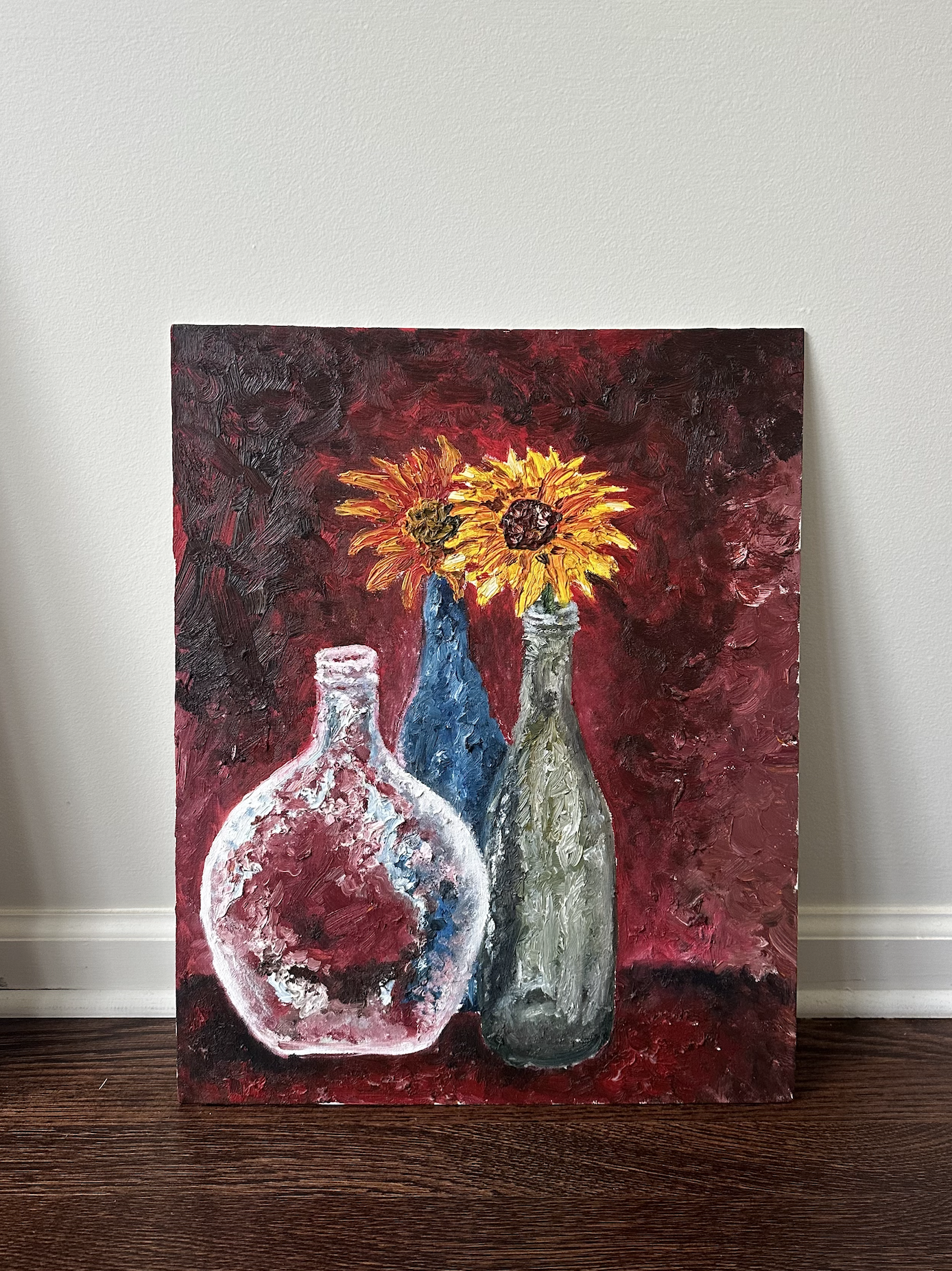 A painting of three vases with flowers on a red background, featuring sunflowers and other flowers.