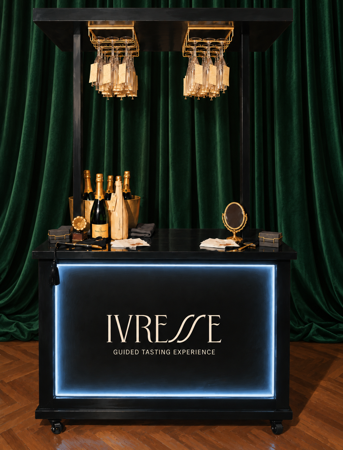 A black bar cart with bottles of champagne, glasses, a small mirror, and business cards for brand activation, set in front of green velvet curtains. The front of the cart displays the text 'IVRESSE GUIDED TASTING EXPERIENCE'.