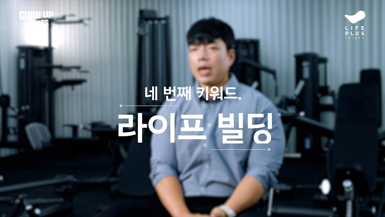 Young man sitting in a gym, with workout equipment in the background, and Korean text overlaying the image.