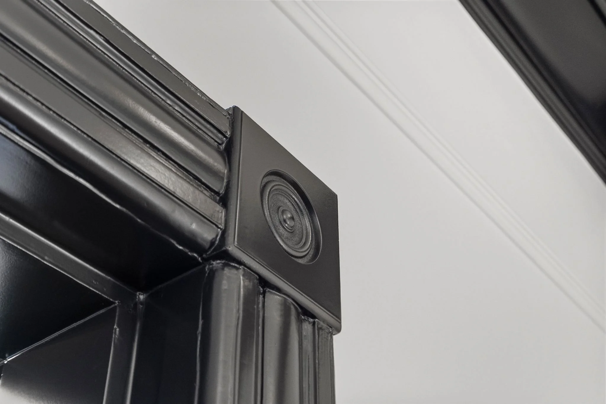 Close-up of black-painted Victorian door casing with rosette corner block