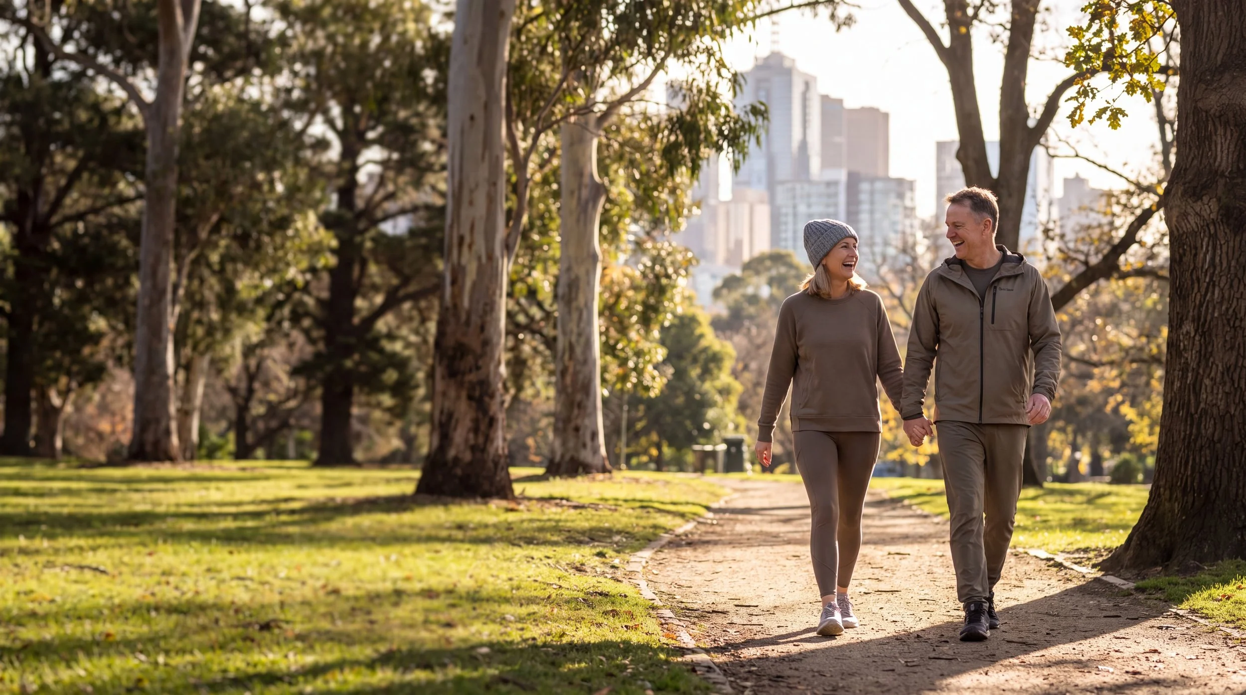 Couple aged over 50 walking through a park, demonstrating the role of regular physical activity in supporting muscle strength, function and independence.